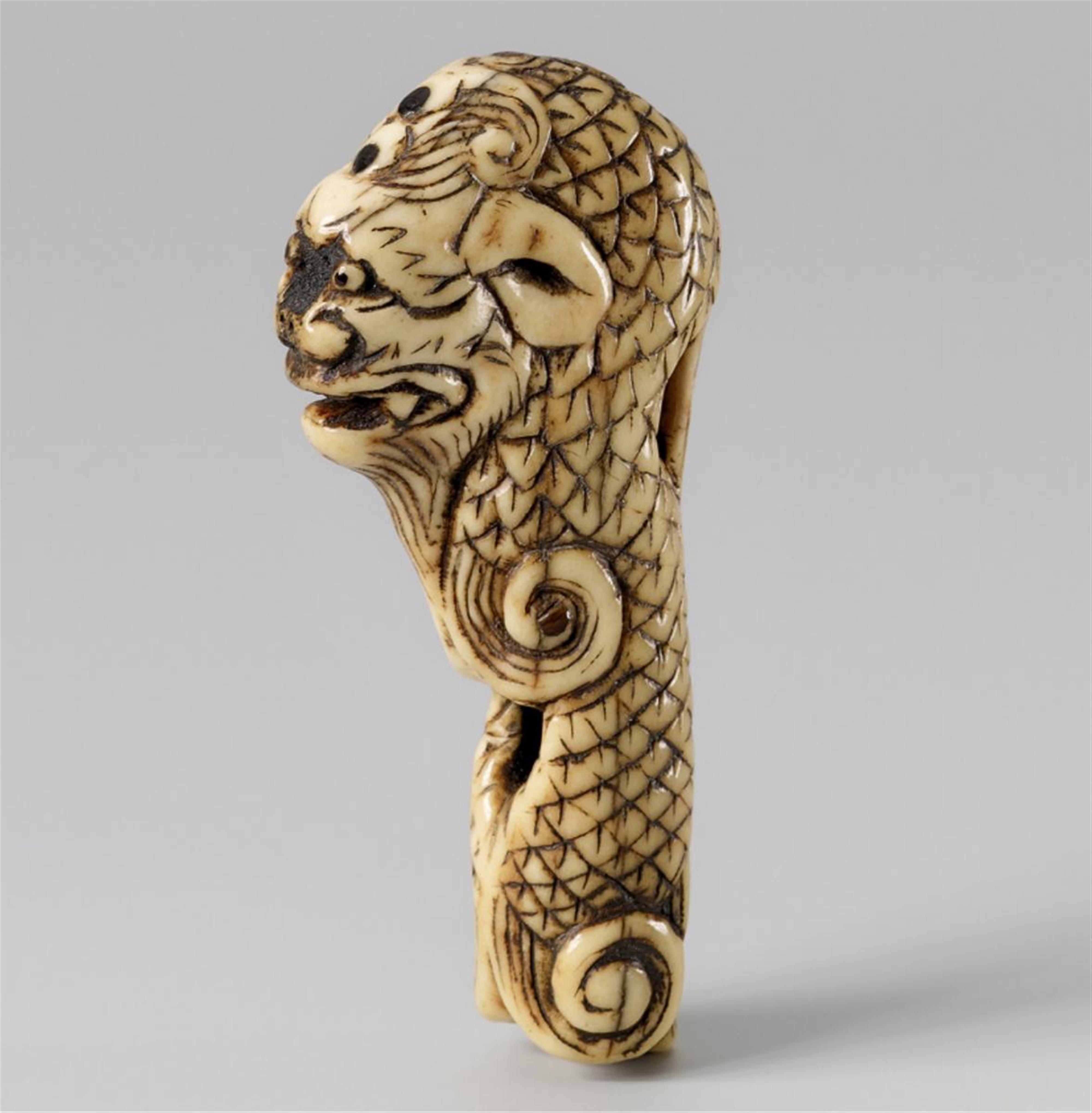 An unusual stag antler netsuke of a dragon. 19th century. - image-1