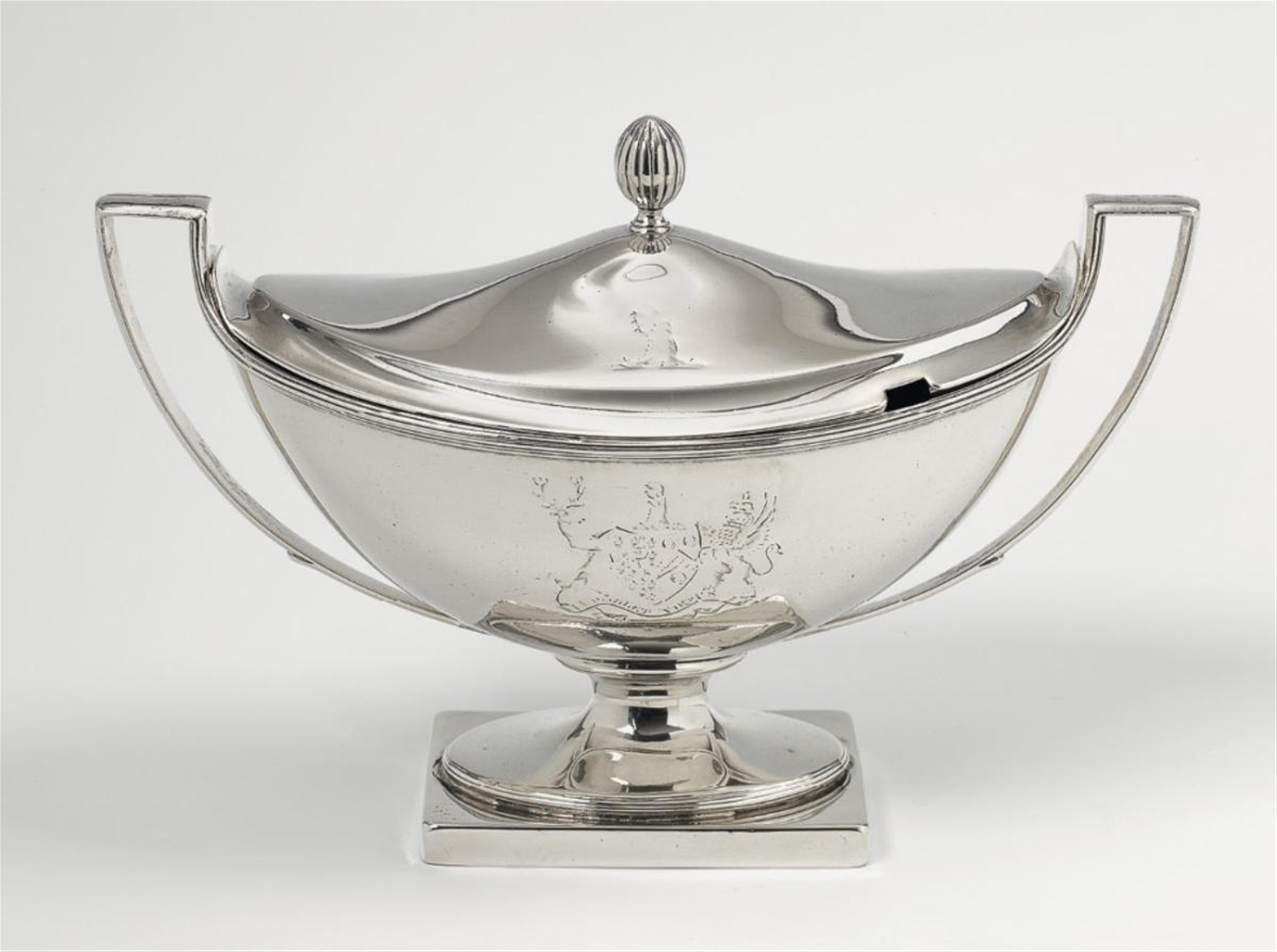 A George III London silver sauceboat and cover. Engraved with a coat-of-arms and motto to the body, the lid with a crest. Marks of Peter Podio, 1792. The engravings worn. - image-1