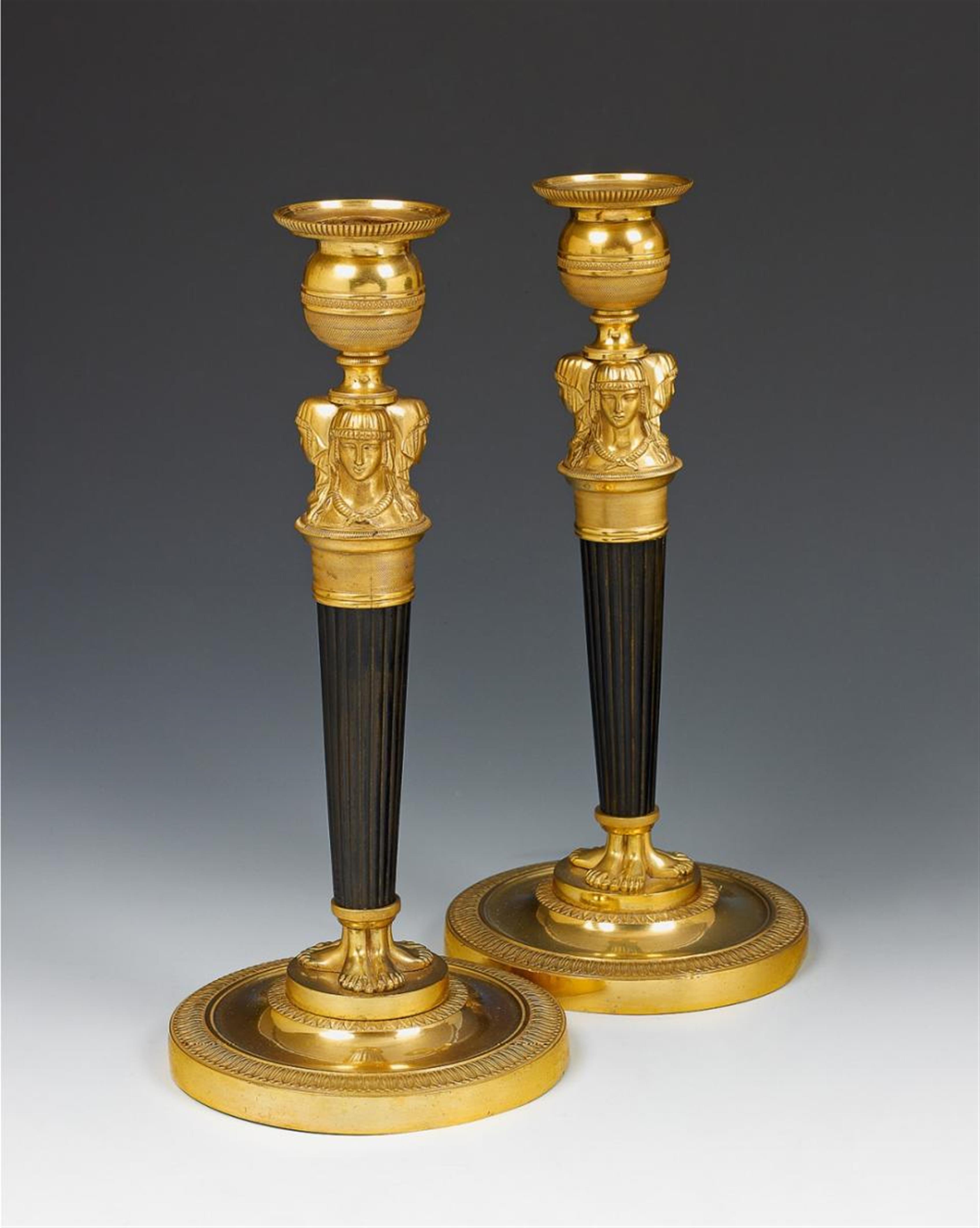 A pair of Parisian époque Empire fire-gilt and burnished bronze candelabra formed as Herms. - image-1