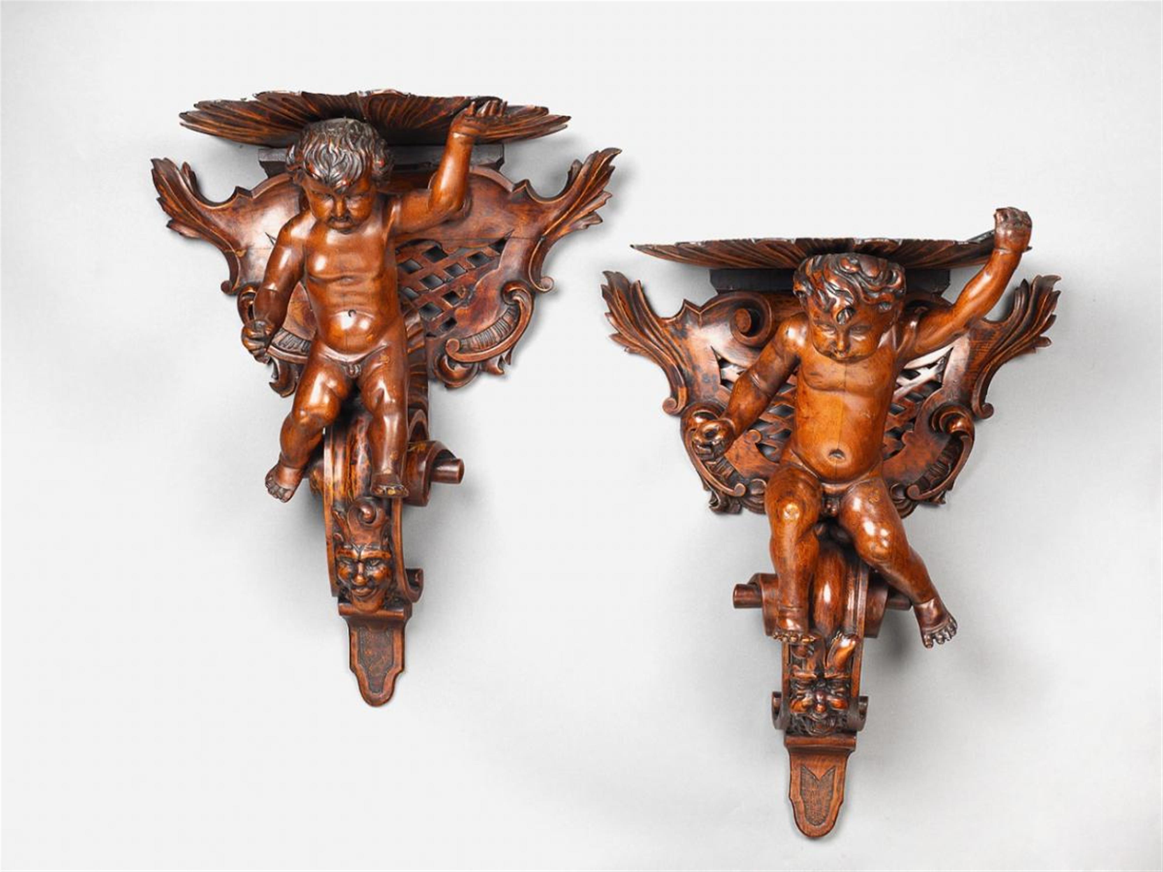 A pair of late 19th century red varnished hardwood brackets with putti. - image-1