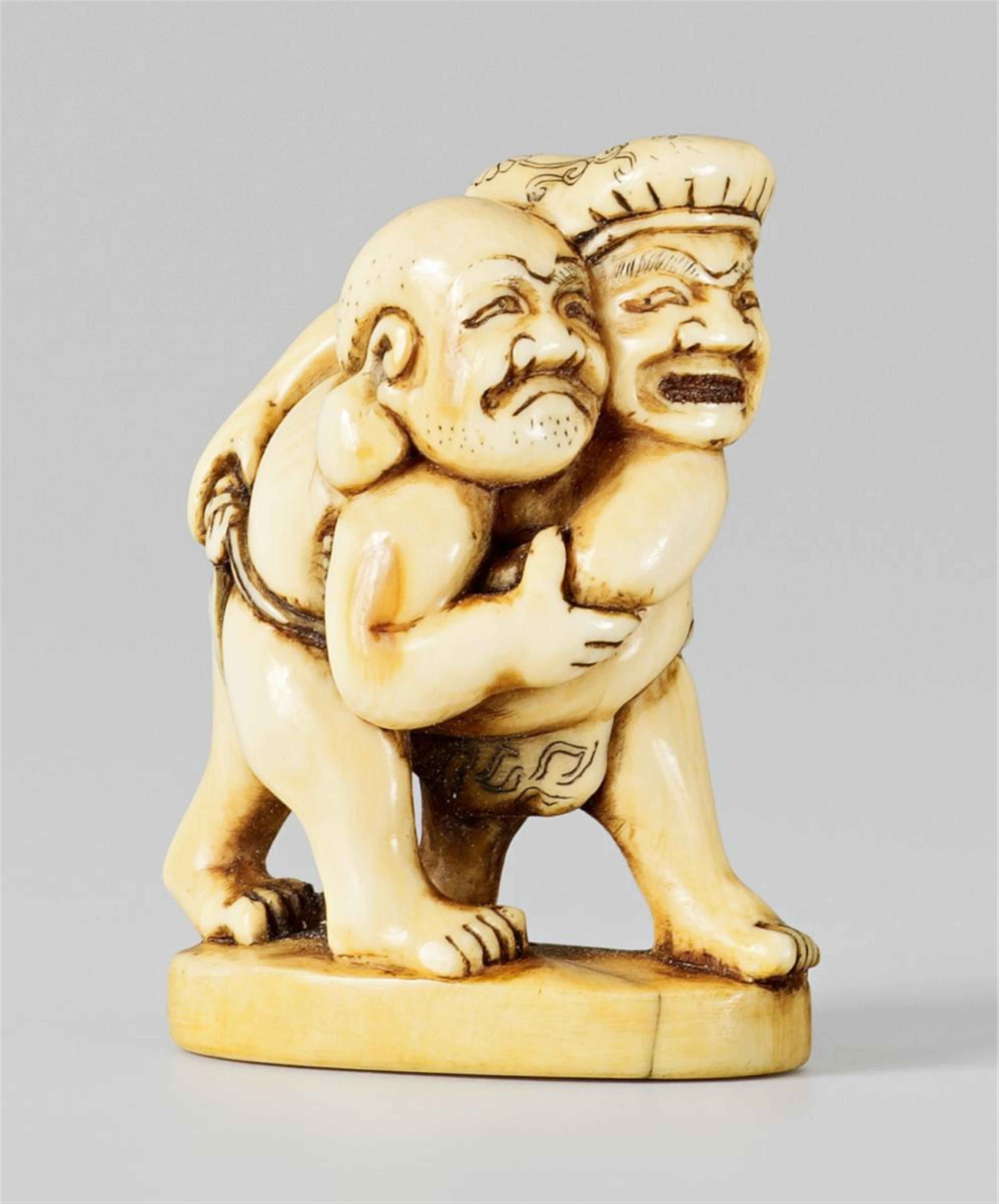 An ivory netsuke of Daikoku and Hotei wrestling. Late 18th century - image-1