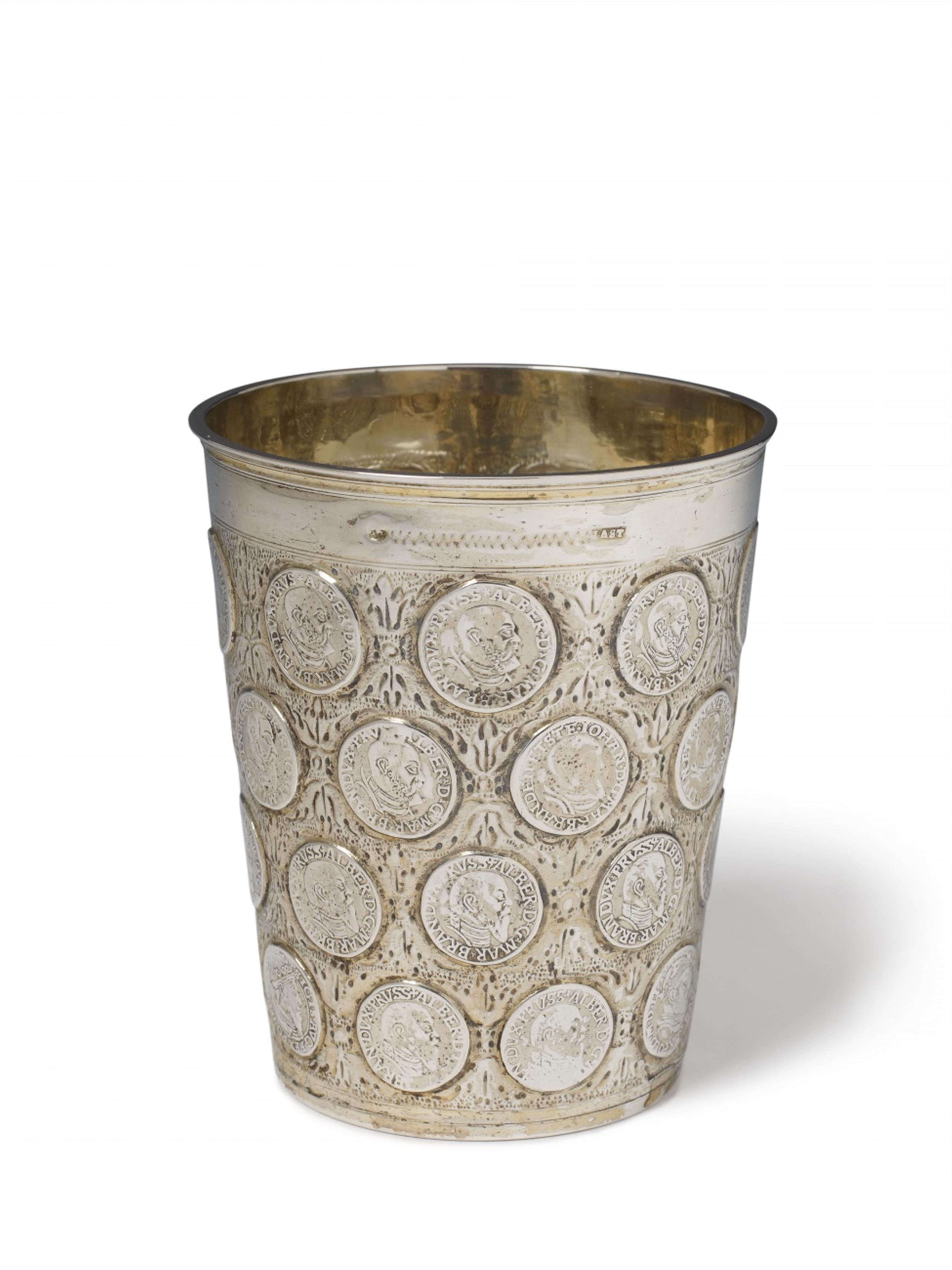 An early Berlin silver partially gilt coin-set beaker. Set with 36 Brandenburg and Polish coins and a medallion commemorating the battle of Fehrbellin on 18th June 1675 to the underside. Marks of Joachim Ast the Elder, ca. 1680. - image-1