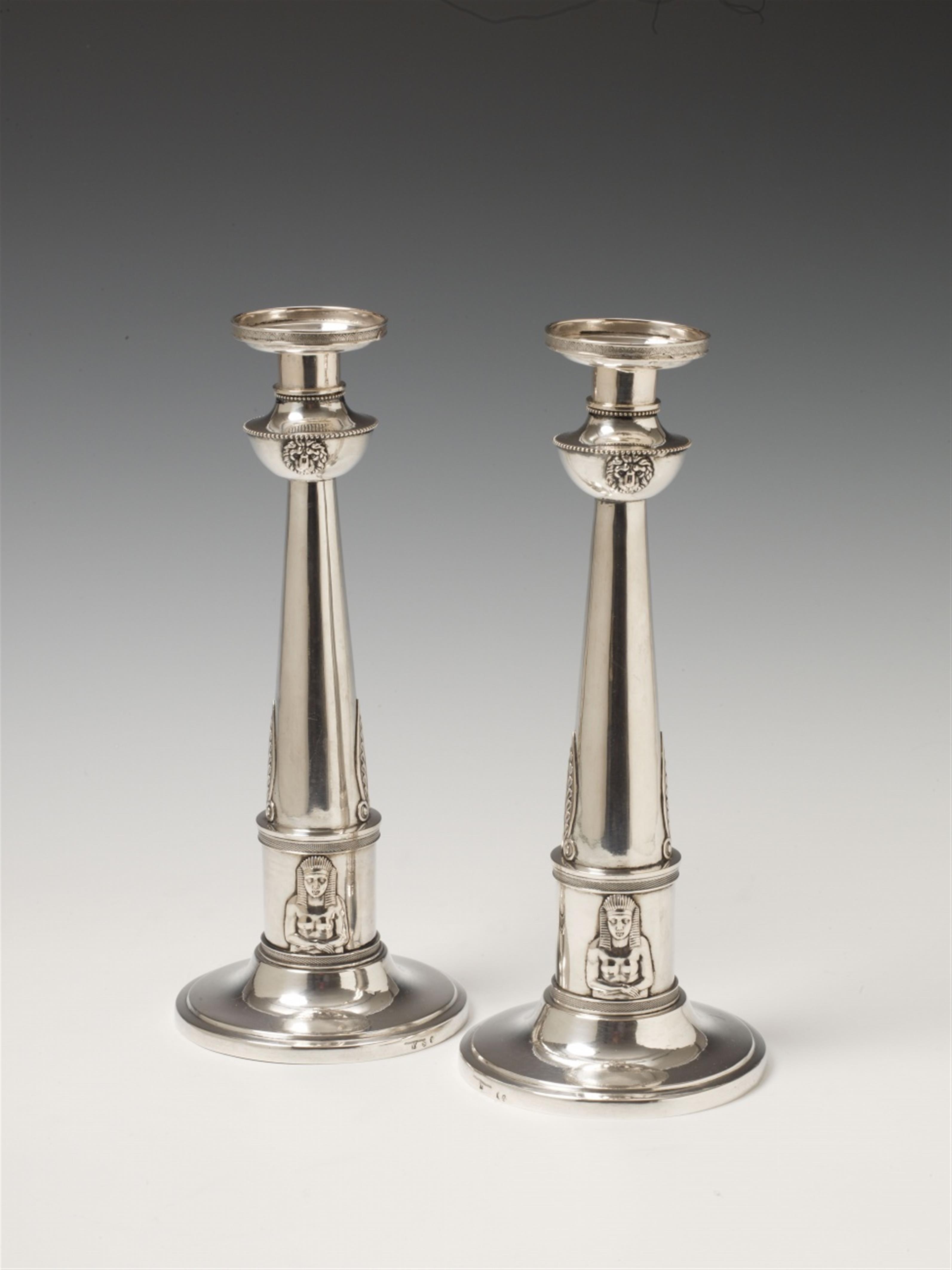 A pair of Nuremberg silver empire candlesticks. With minor soldered repairs to the drip pans. Marks of Johann Friedrich Wilhelm Kramer, 1808 - 20. - image-1