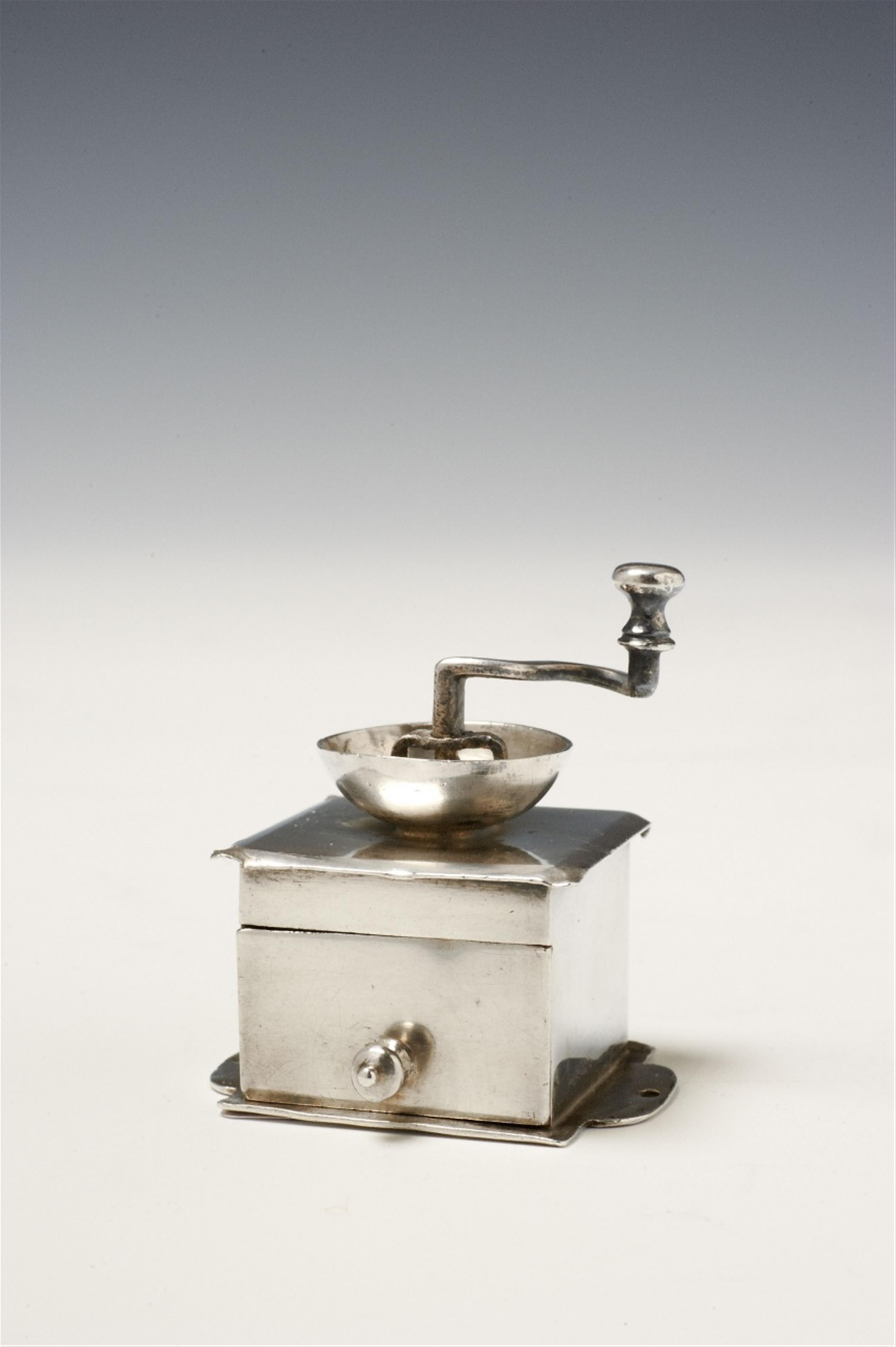 An Amsterdam silver miniature coffee grinder. Monogrammed "A.M:H:E:N." to the underside. Marks of Arnoldus van Geffen, 1753. - image-1