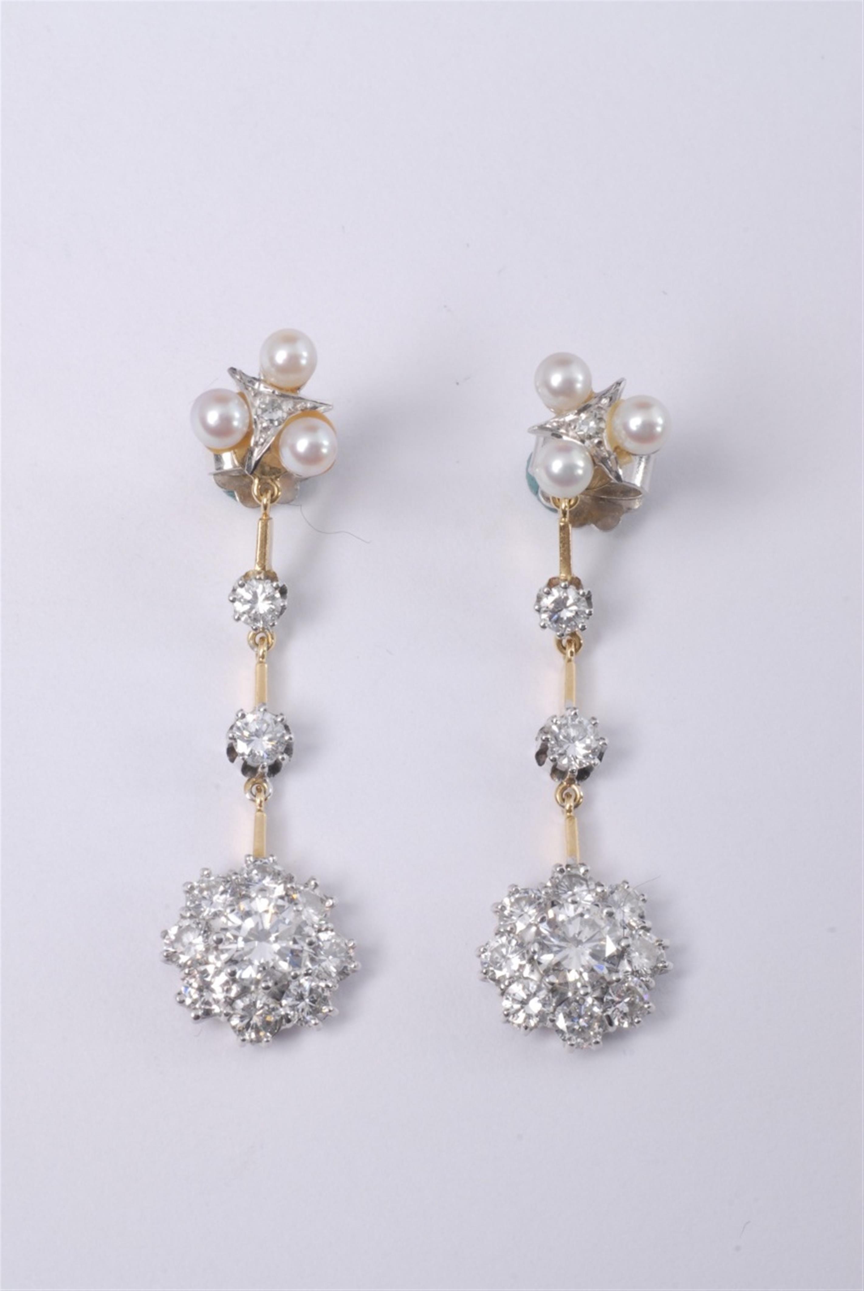 A pair of 18k white and yellow gold and diamond earrings. - image-1