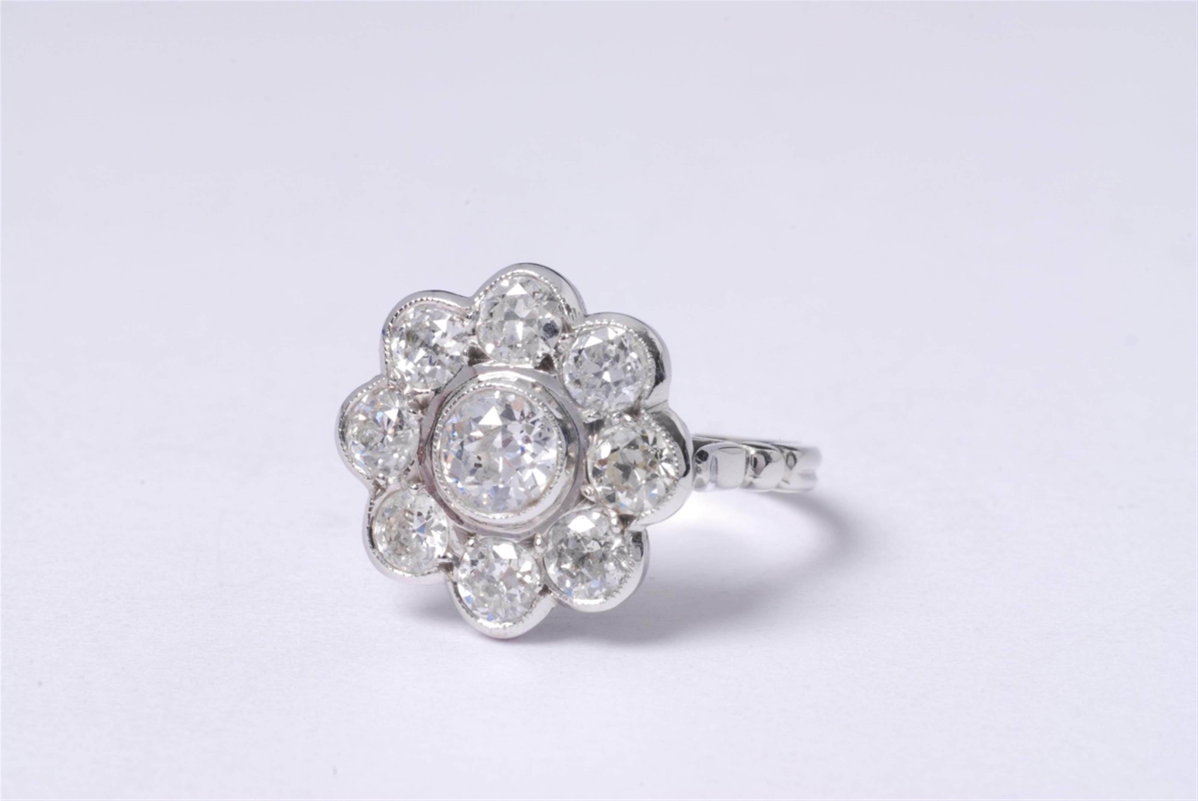 An English 18k white gold and diamond ring. - image-1