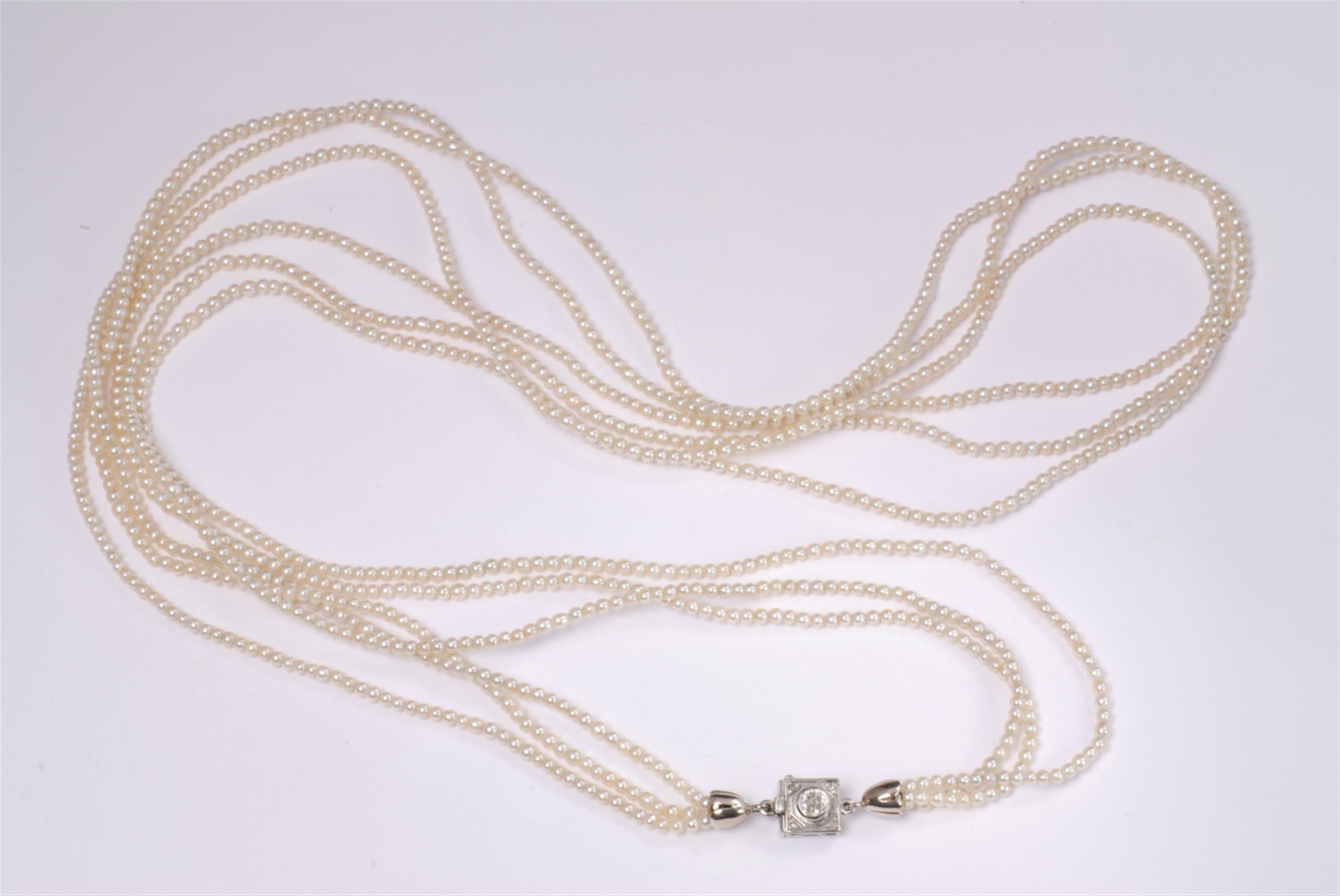 A three stranded 18k white gold and pearl sautoir. - image-1