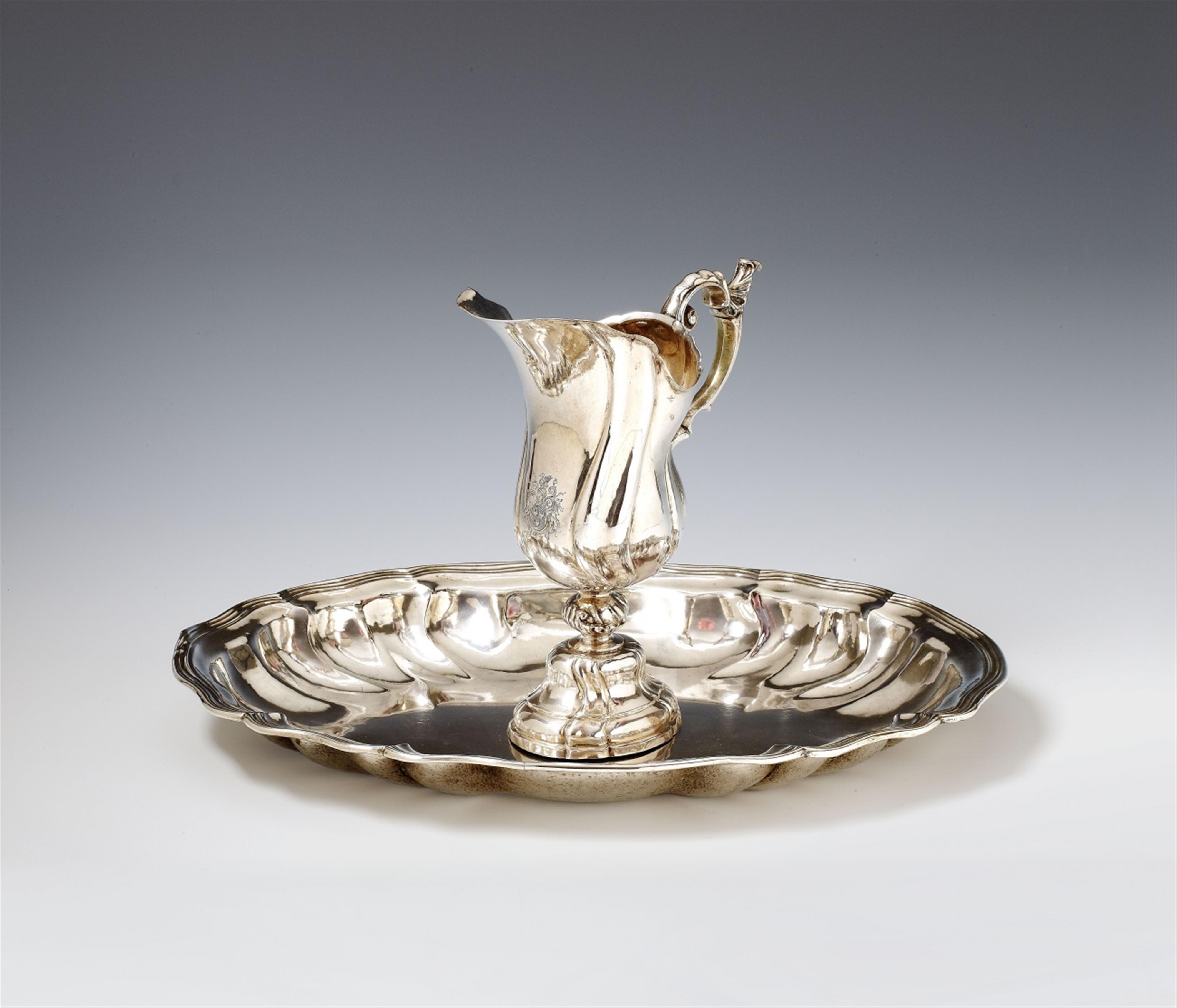 An Augsburg silver washbasin and pitcher set. The pitcher with an engraved coat of arms. Marks of Adolf Carl Holm, 1759 - 61. - image-1