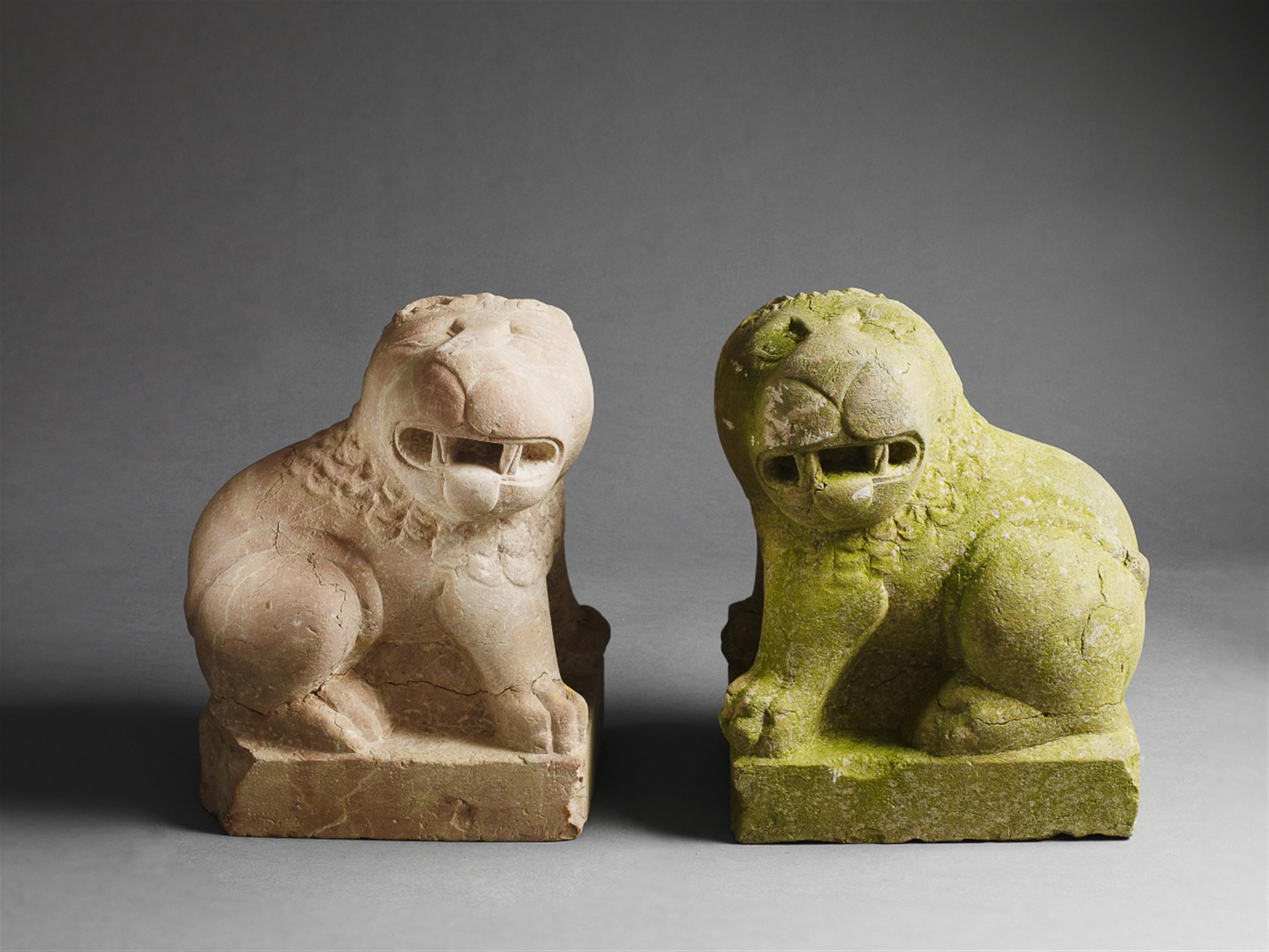 A pair of recumbent red sandstone lions. - image-1