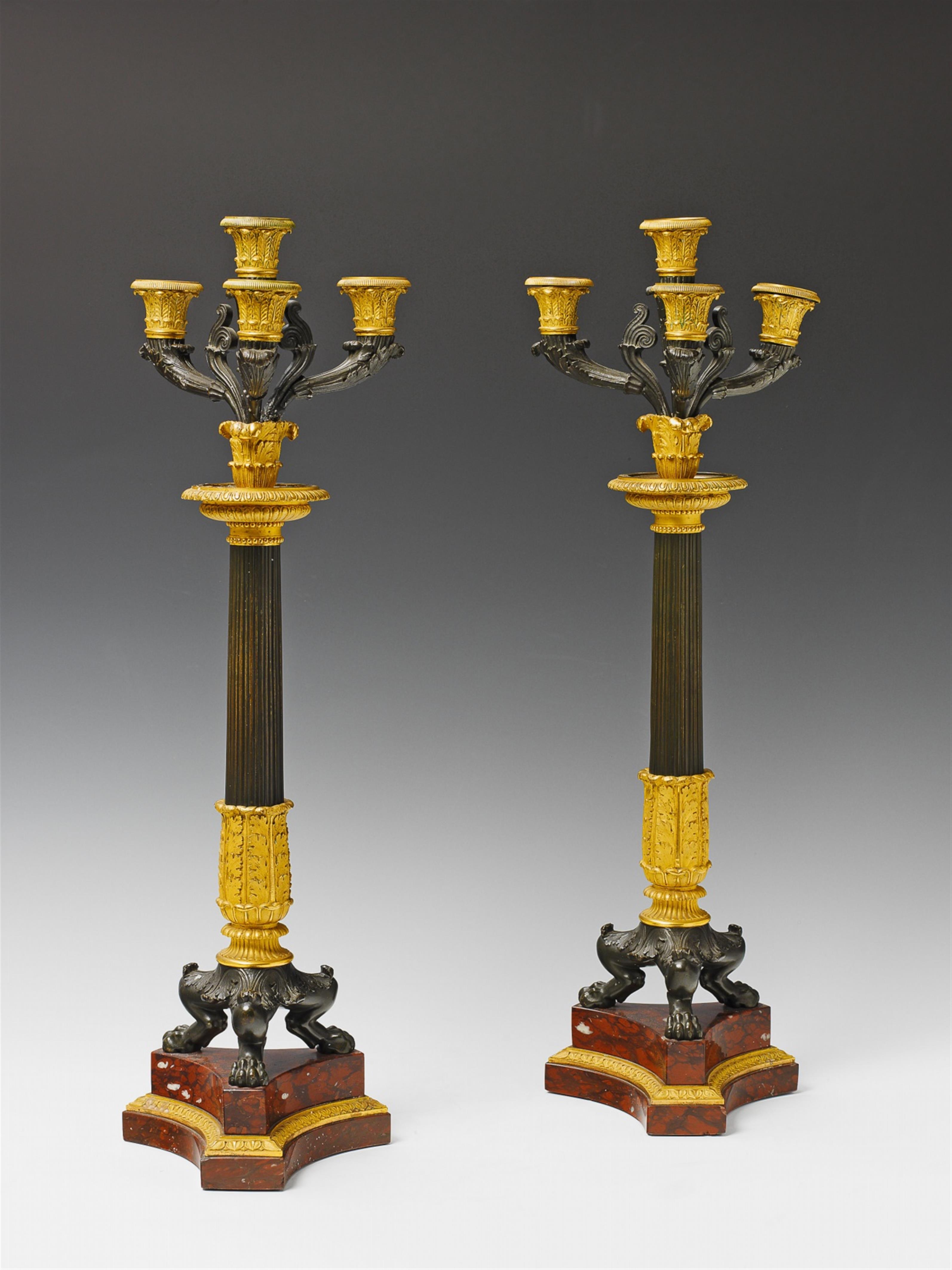 A pair of French époque Restauration bronze four-flame candelabra. - image-1