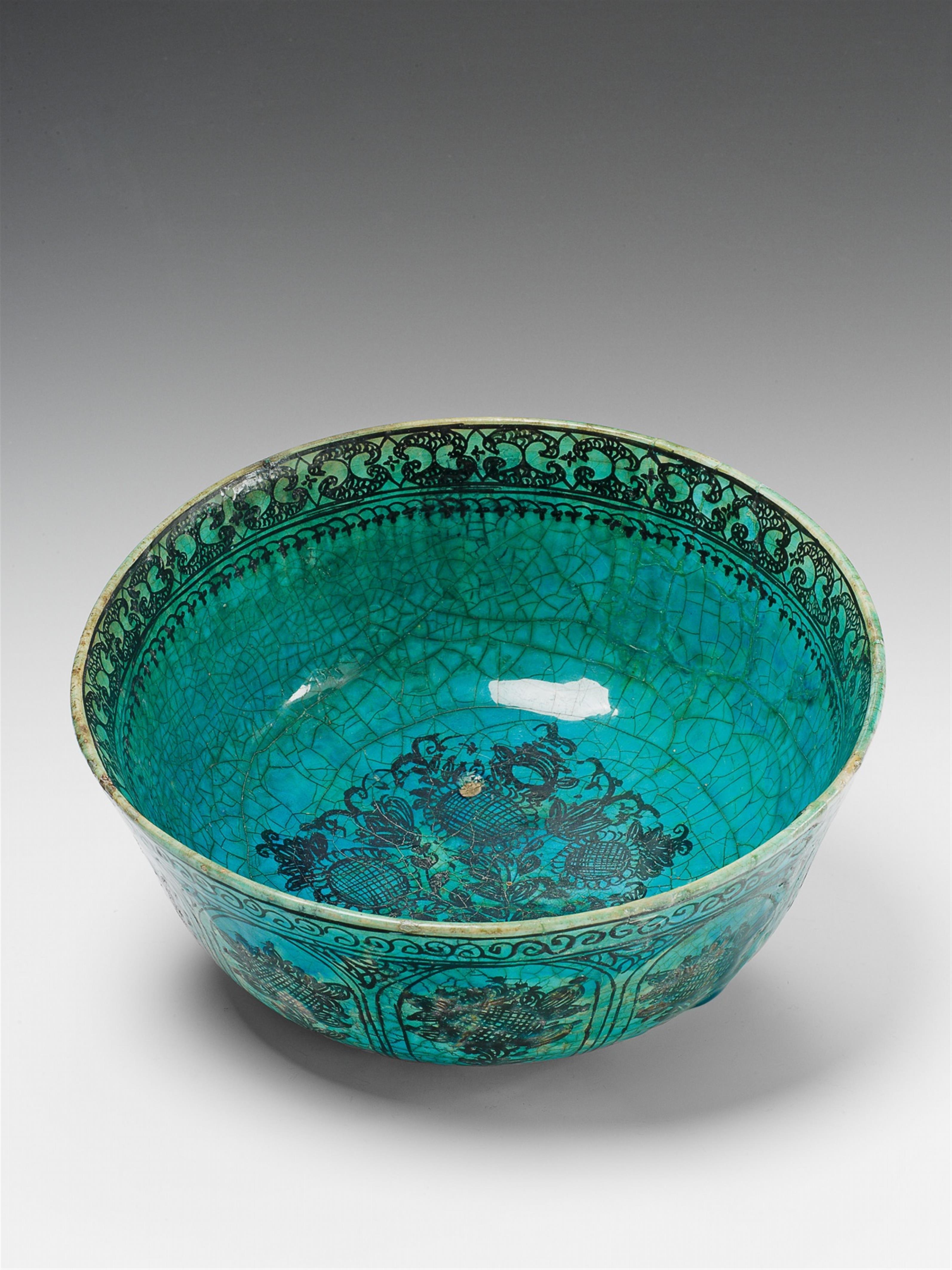 An Iranian ceramic bowl with floral decor. - image-1