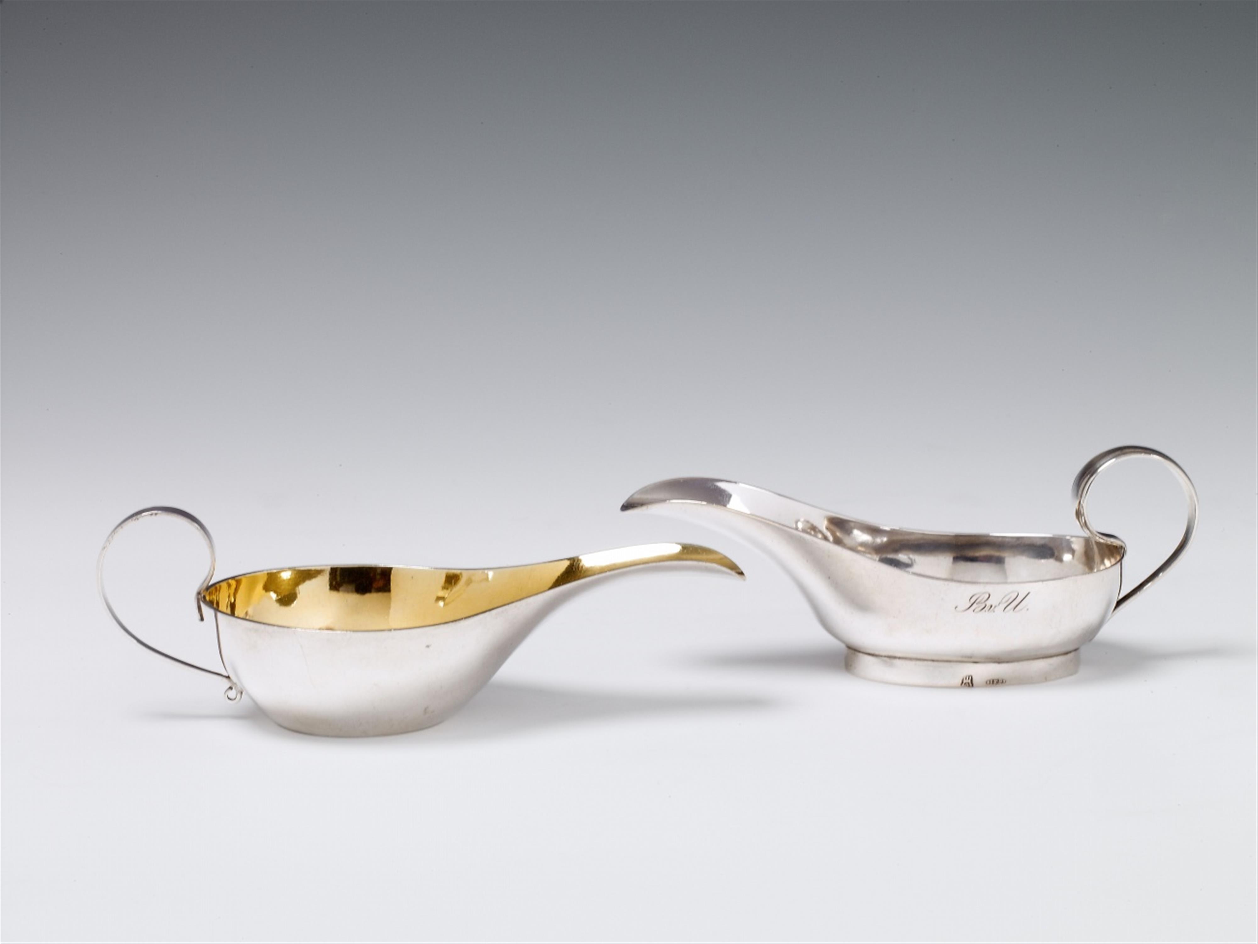 Two silver pap boats. One interior gilt, one monogrammed "B.v.U.". One with Hamburg marks of Johann Friedrich Brahmfeld, the other with an unidentified mark "F.Breuer", ca. 1830. - image-1