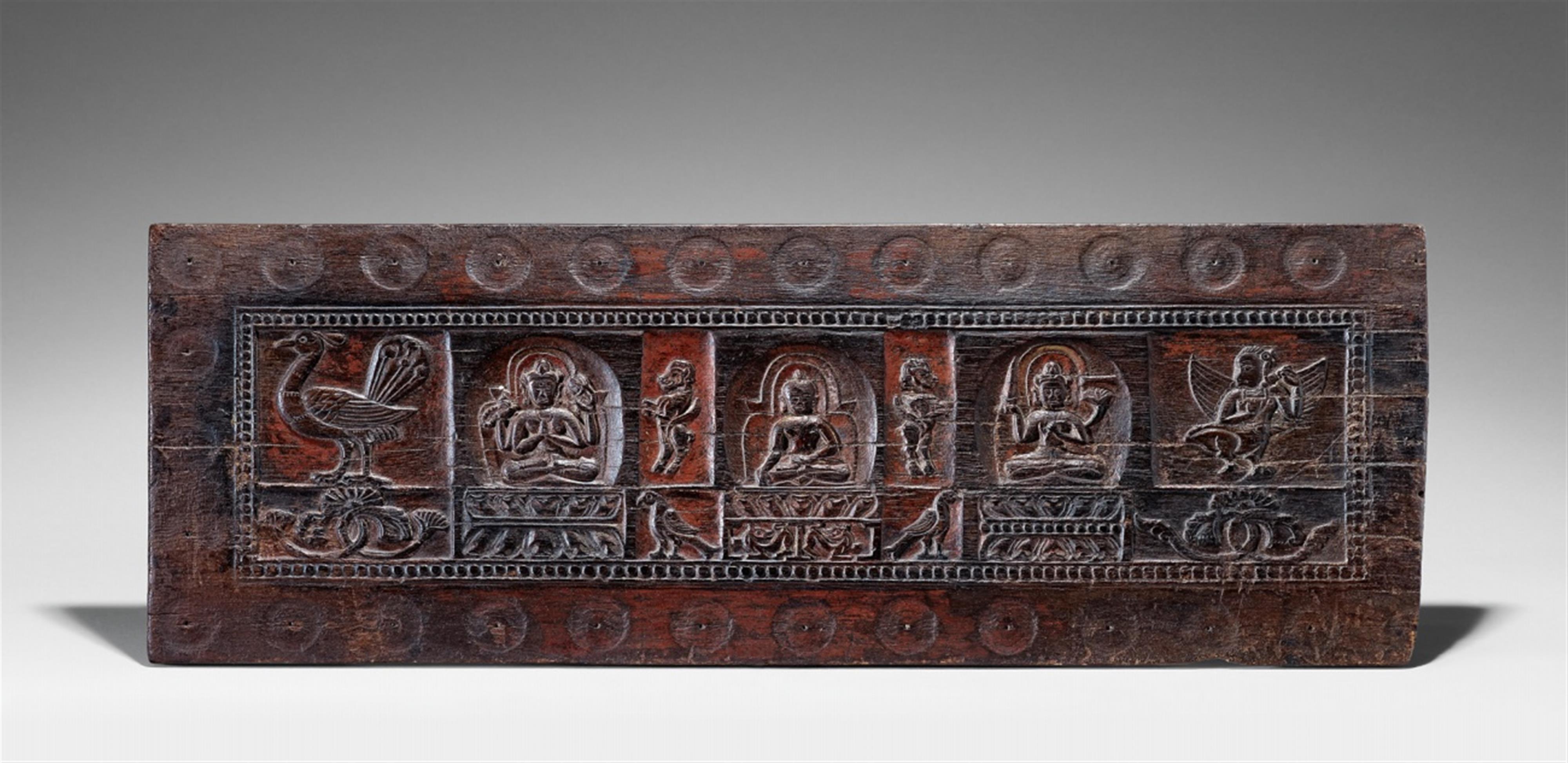 A Tibetan carved wooden manuscript cover. Possibly 14th/15th century - image-1