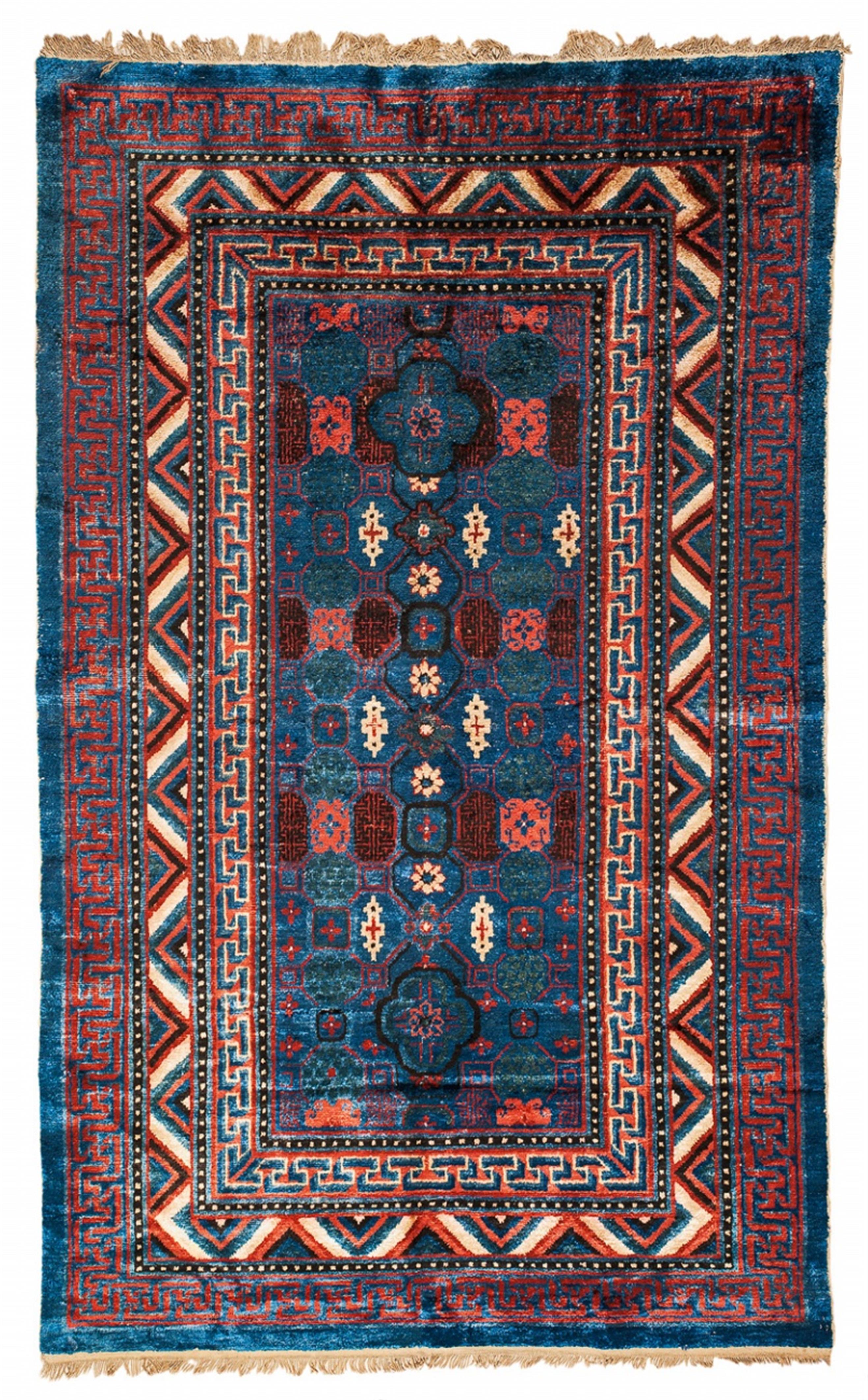 A Chinese/Eastern Turkestani silk khotan carpet with calligraphic decor. - image-1