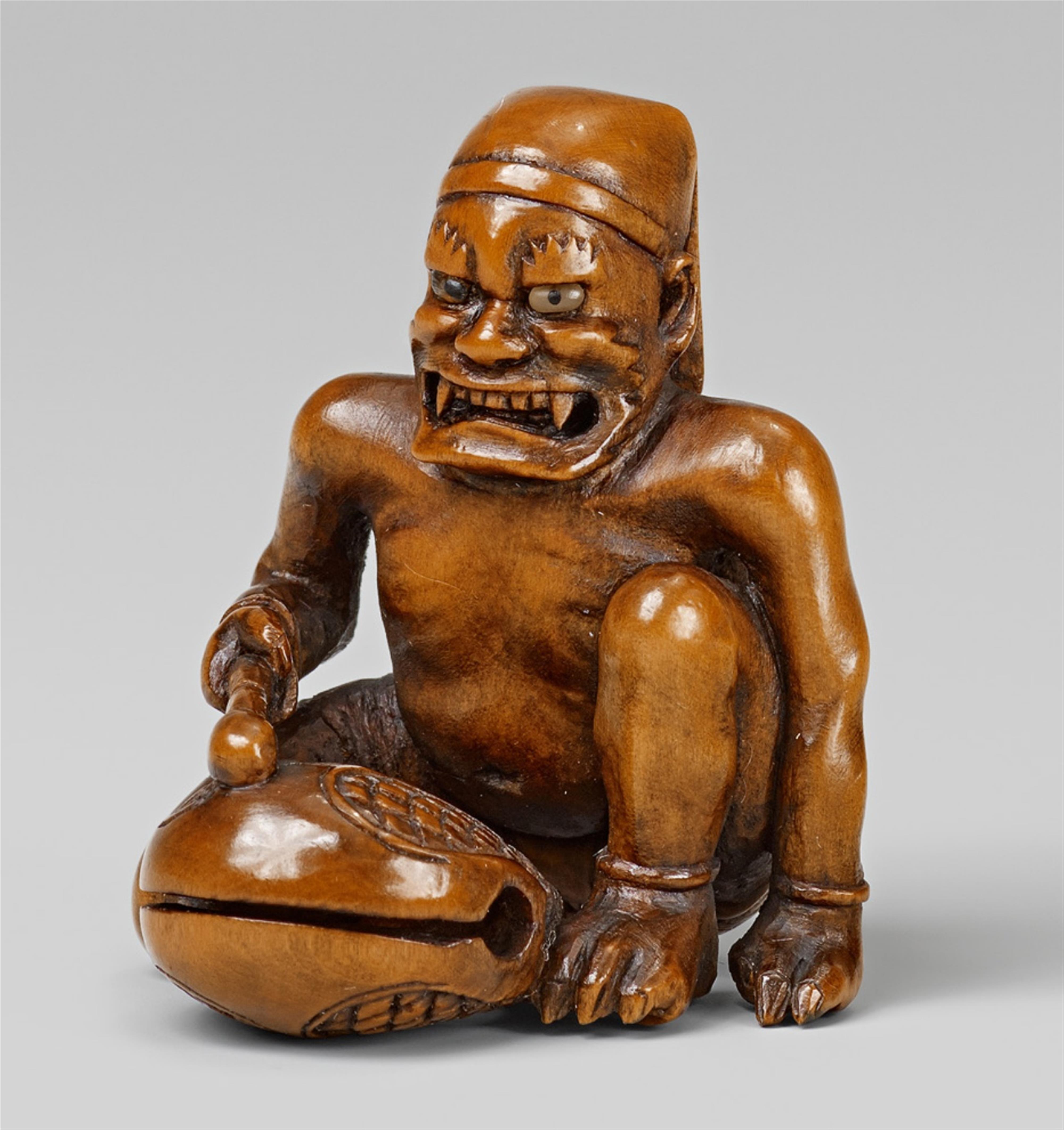 A large boxwood netsuke of an oni with a mokugyo. Mid-19th century - image-1