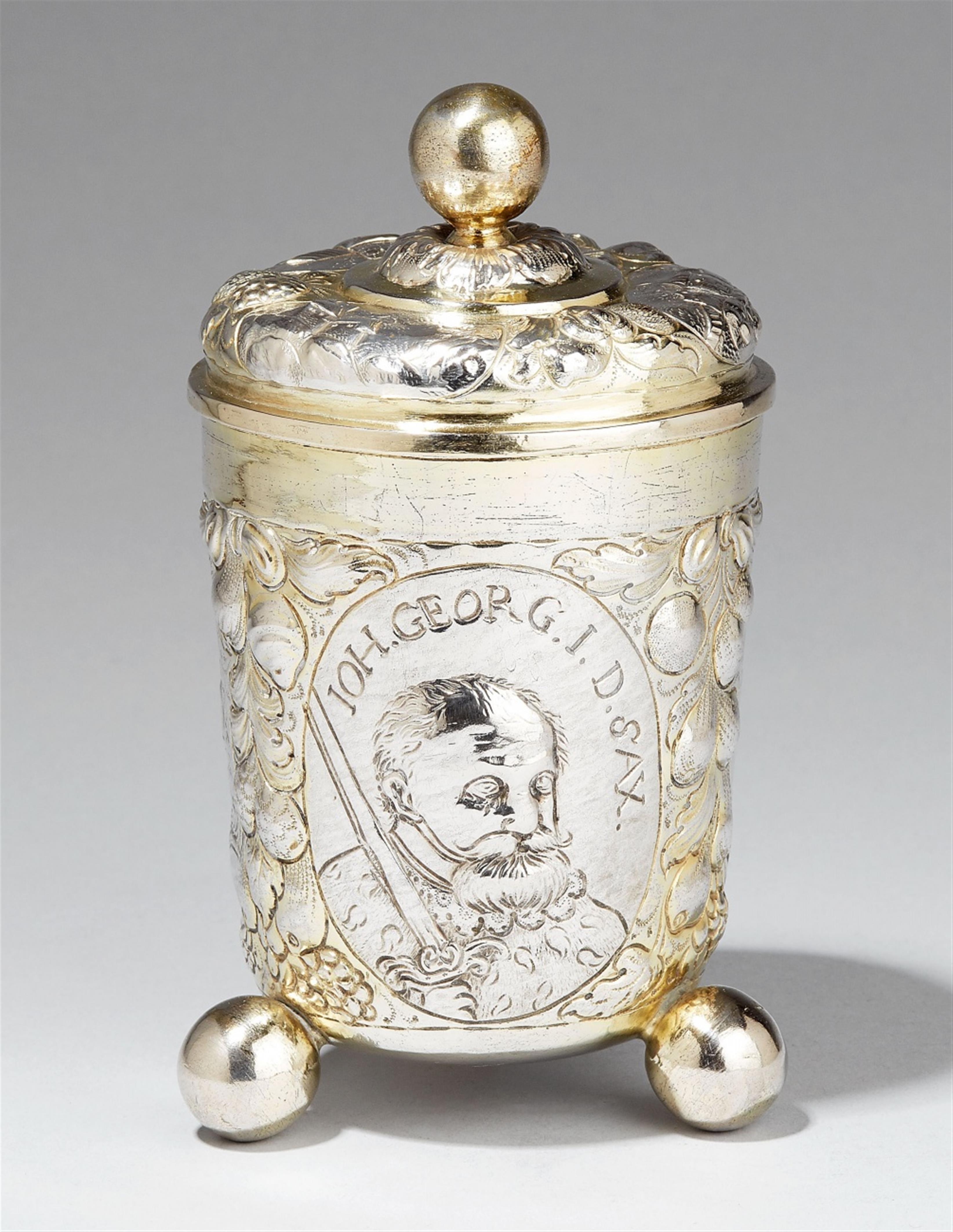 A Leipzig partially gilt silver beaker. With three portrait medallions of the Saxon electors George I, II & III, each inscribed "IOH. GEORG DSAX". Marks of Franz Finsinger, ca. 1680. - image-1