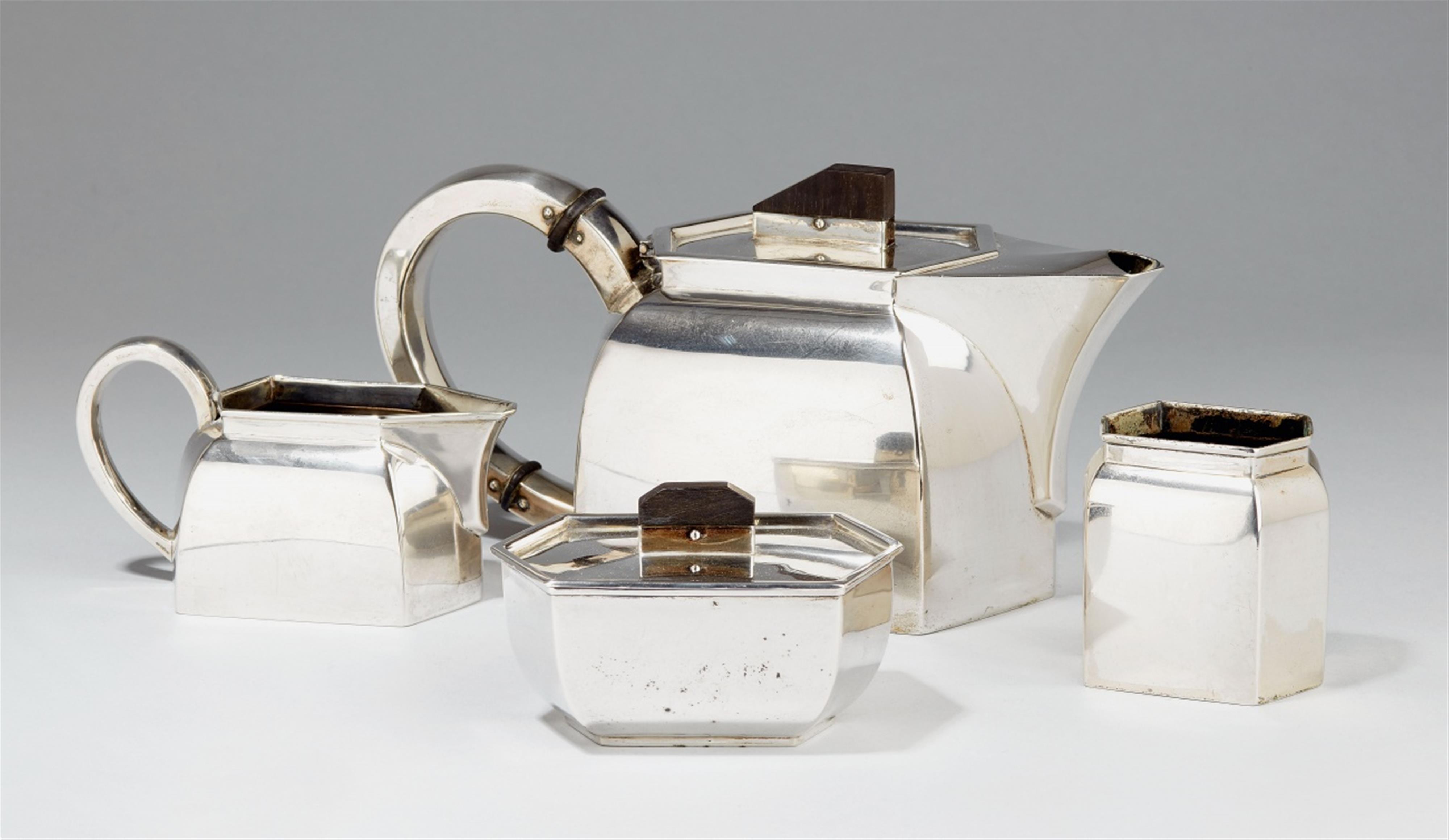 An Art Deco silver tea service. The handles of ebony. Comprising coffee pot, sugar box, milk jug, spoon rest. No maker's mark, presumably Belgium, ca. 1930. - image-1