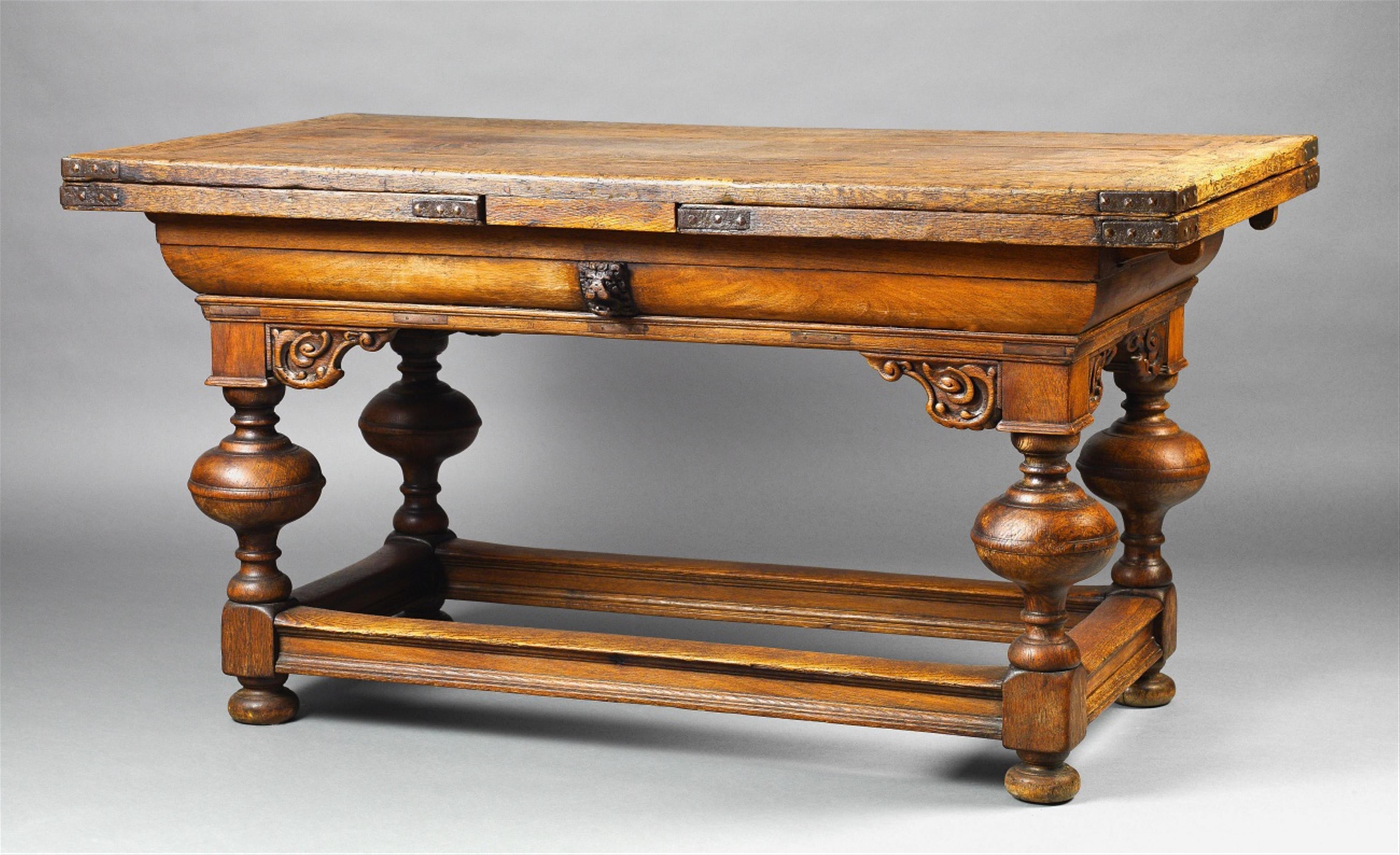 A baroque iron-mounted oak extendable table - image-1
