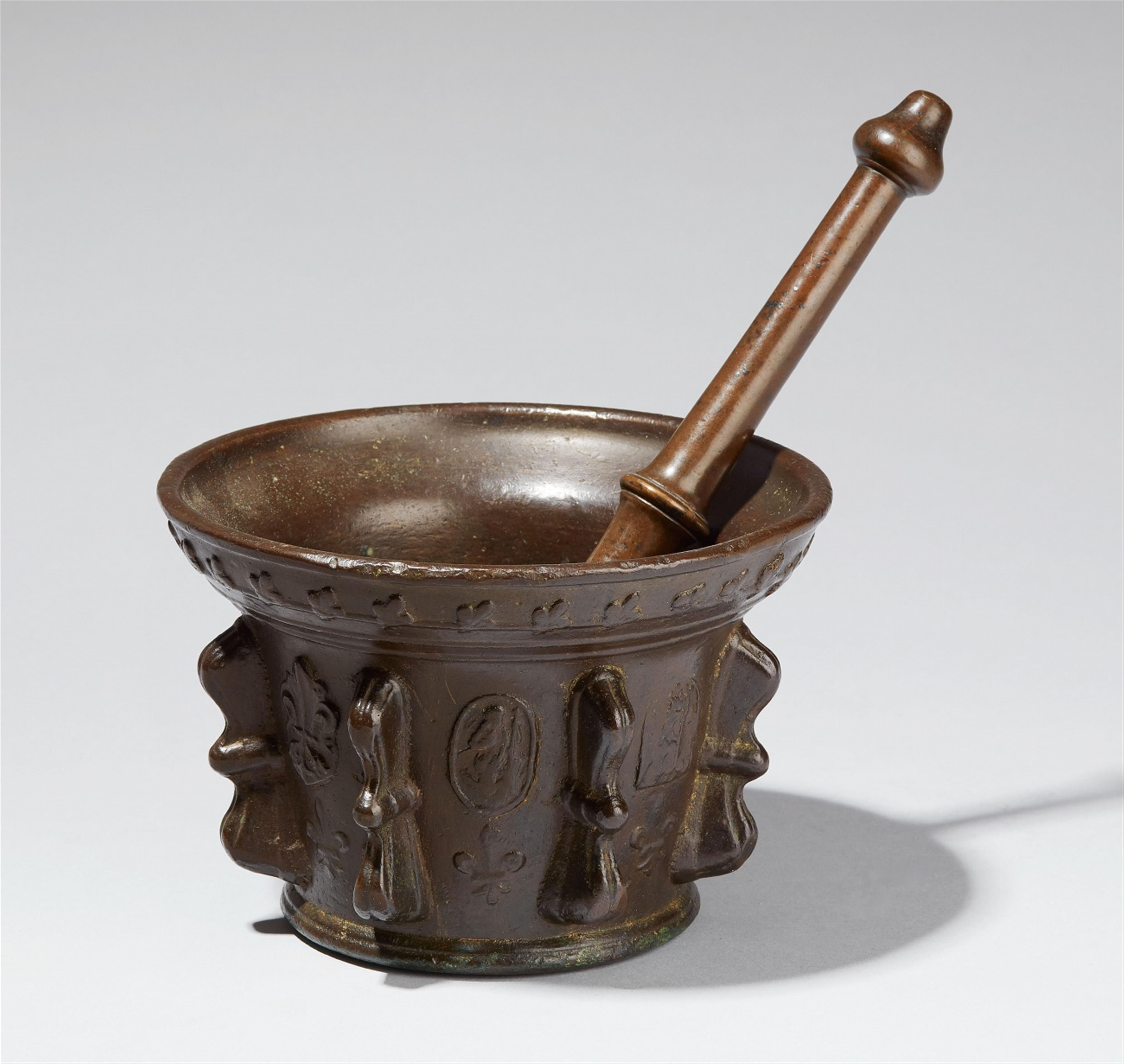 A French ribbed bronze mortar with relief decor - image-1