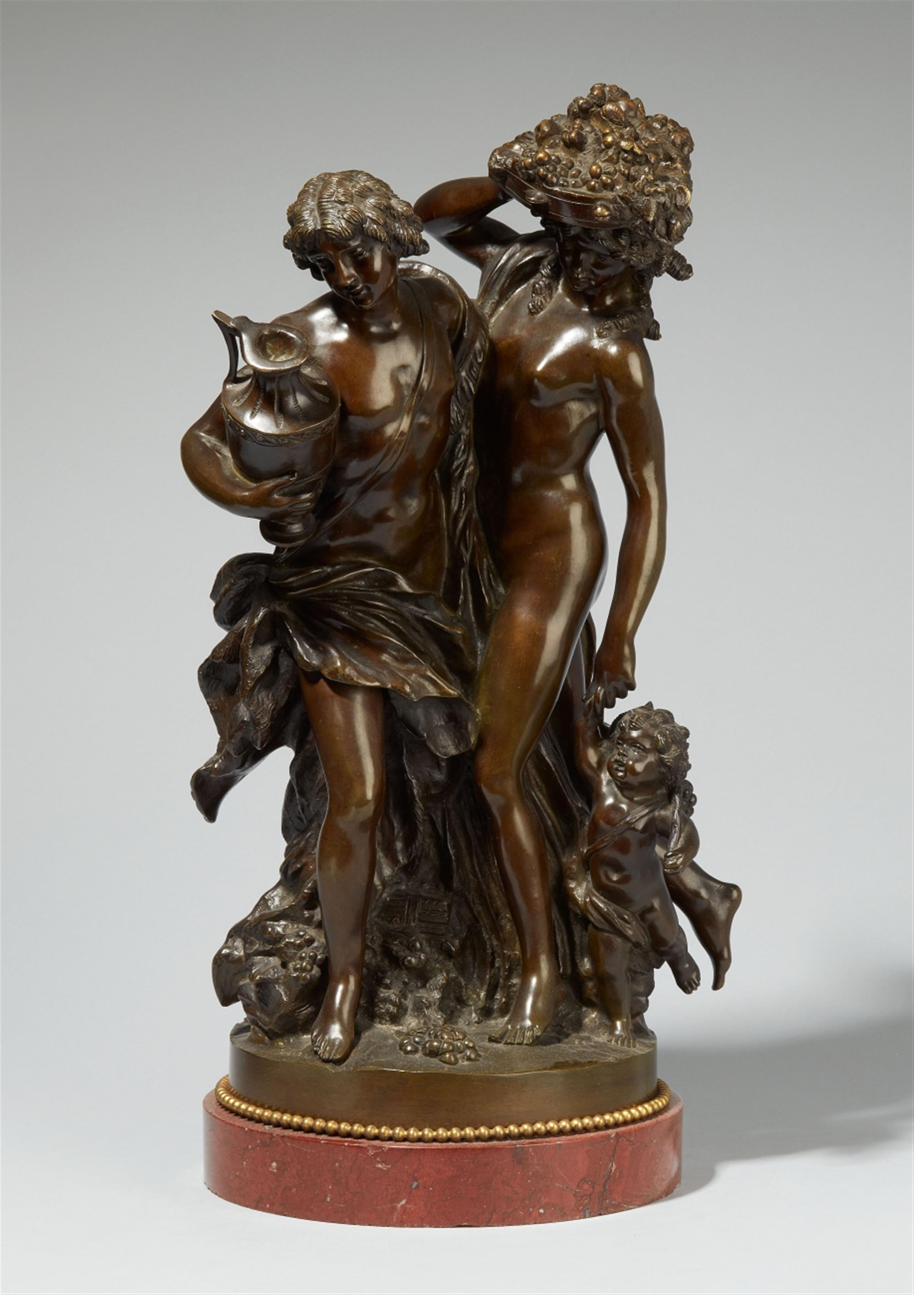 A burnished bronze group of two maenads with a child - image-1