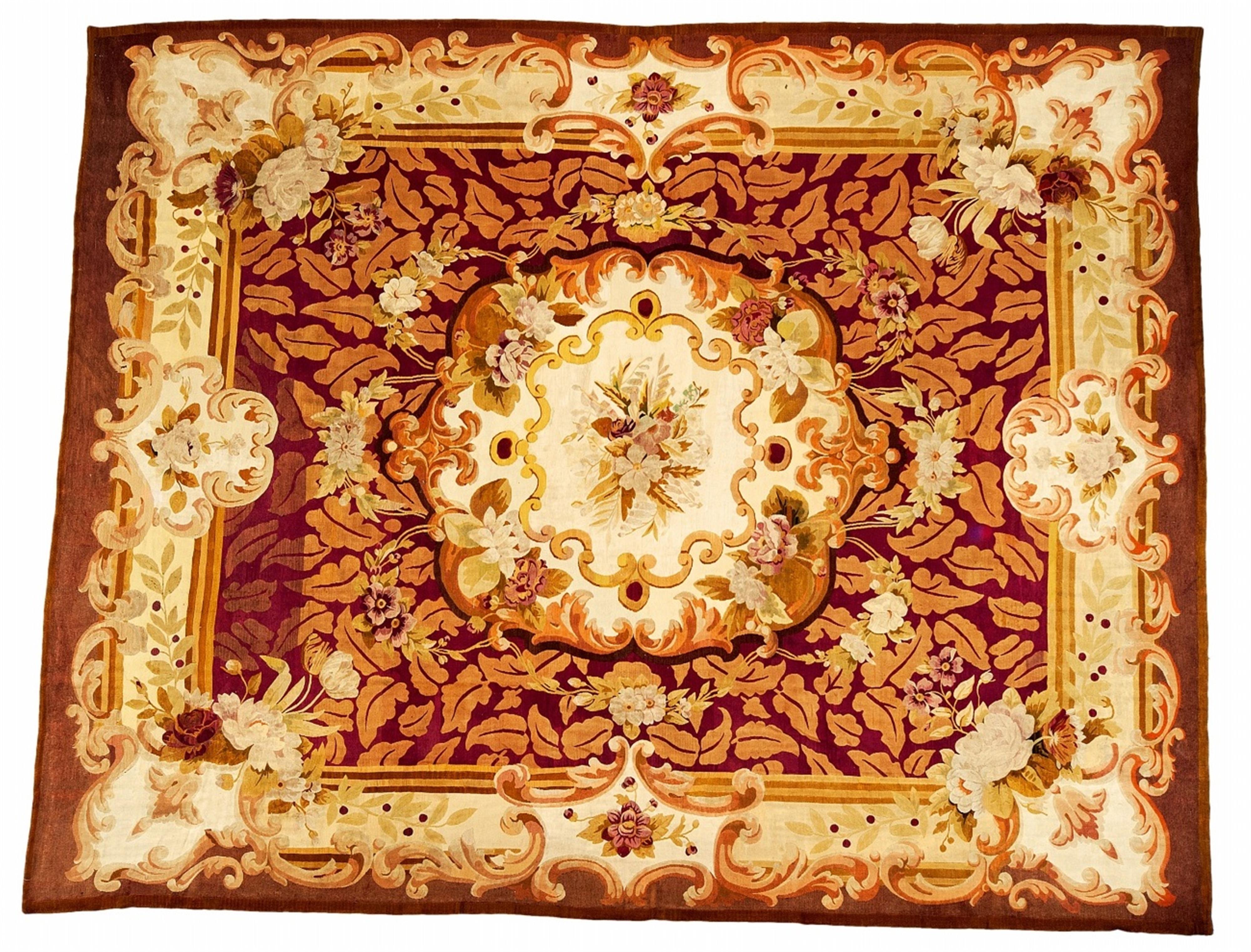 A French woolen Aubusson with medallion on a fuscia ground - image-1