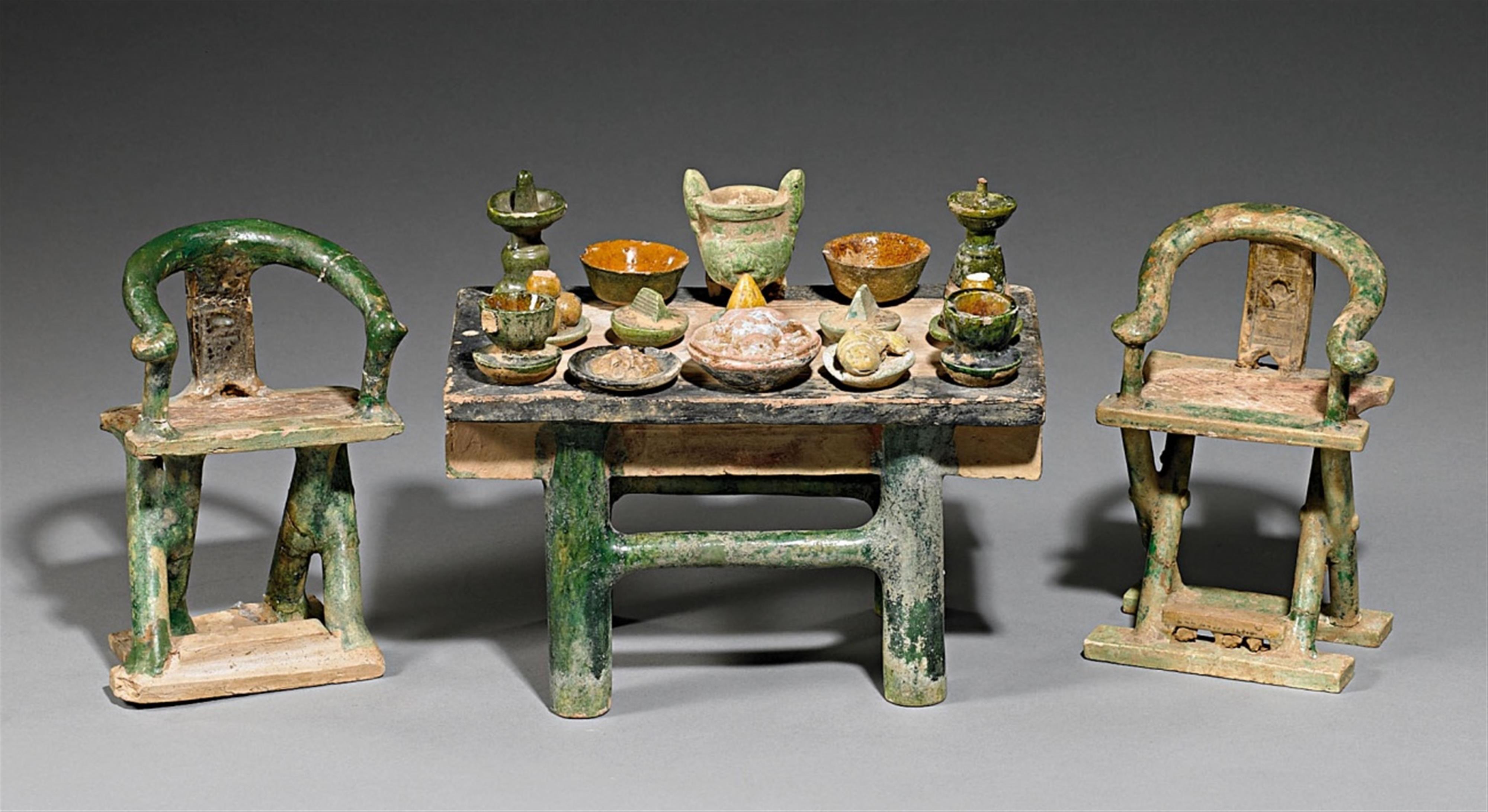 A model of a table set with food and two chairs. Ming dynasty (1368-1644) - image-1