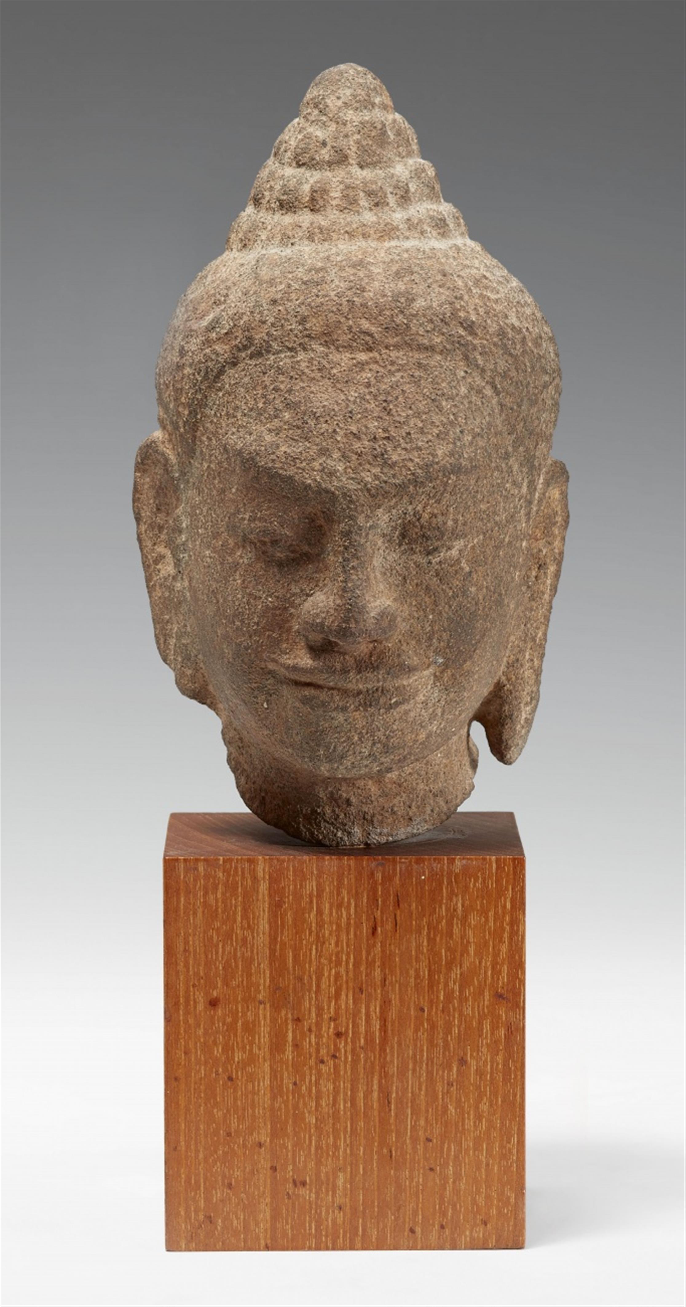 A Bayon-style sandstone head of a deity. Angkor period, 12th/13th century - image-1