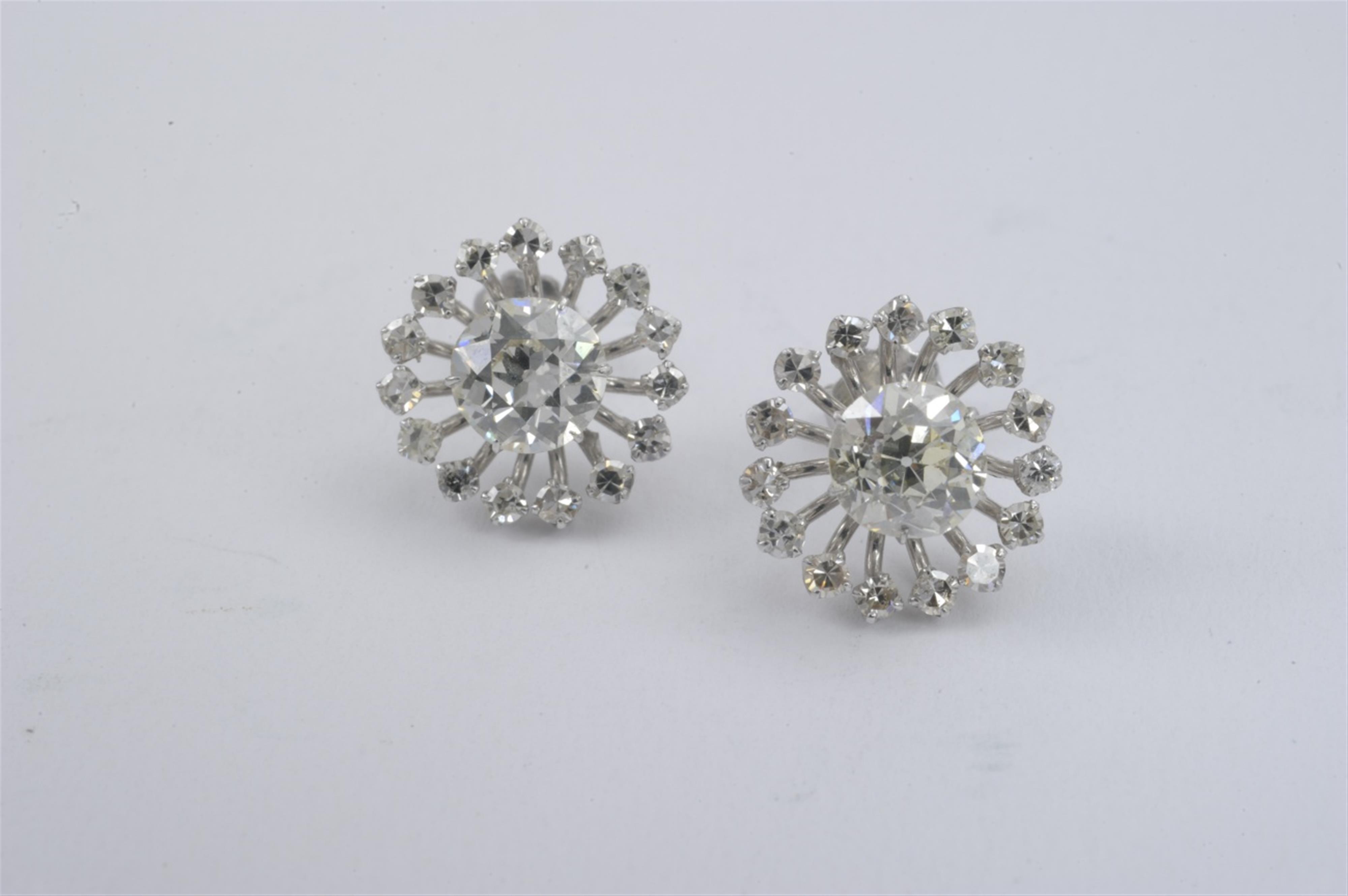 A pair of 14k white gold and diamond stud earrings - image-1