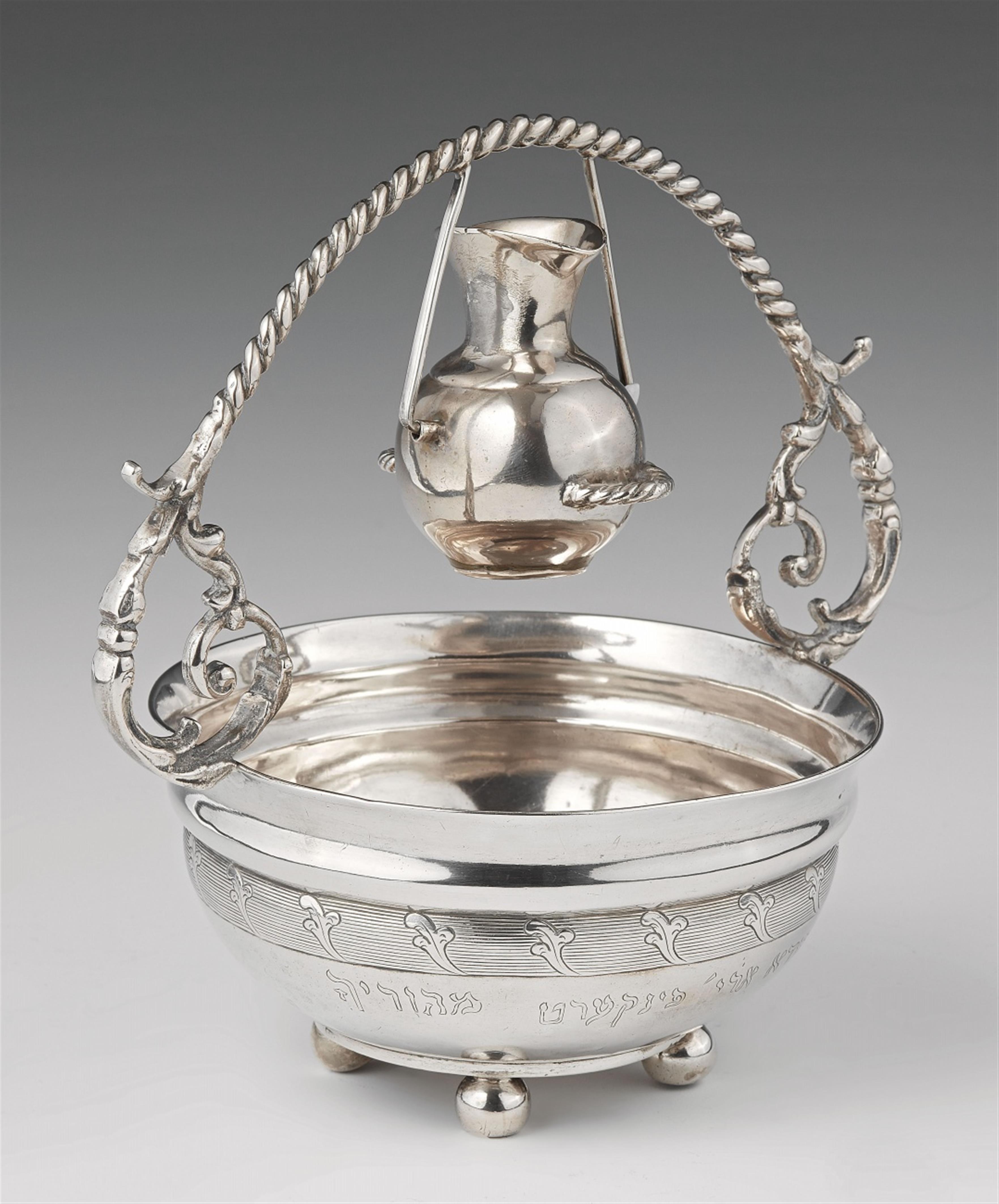 A silver and white metal netilat yadayim dish - image-1