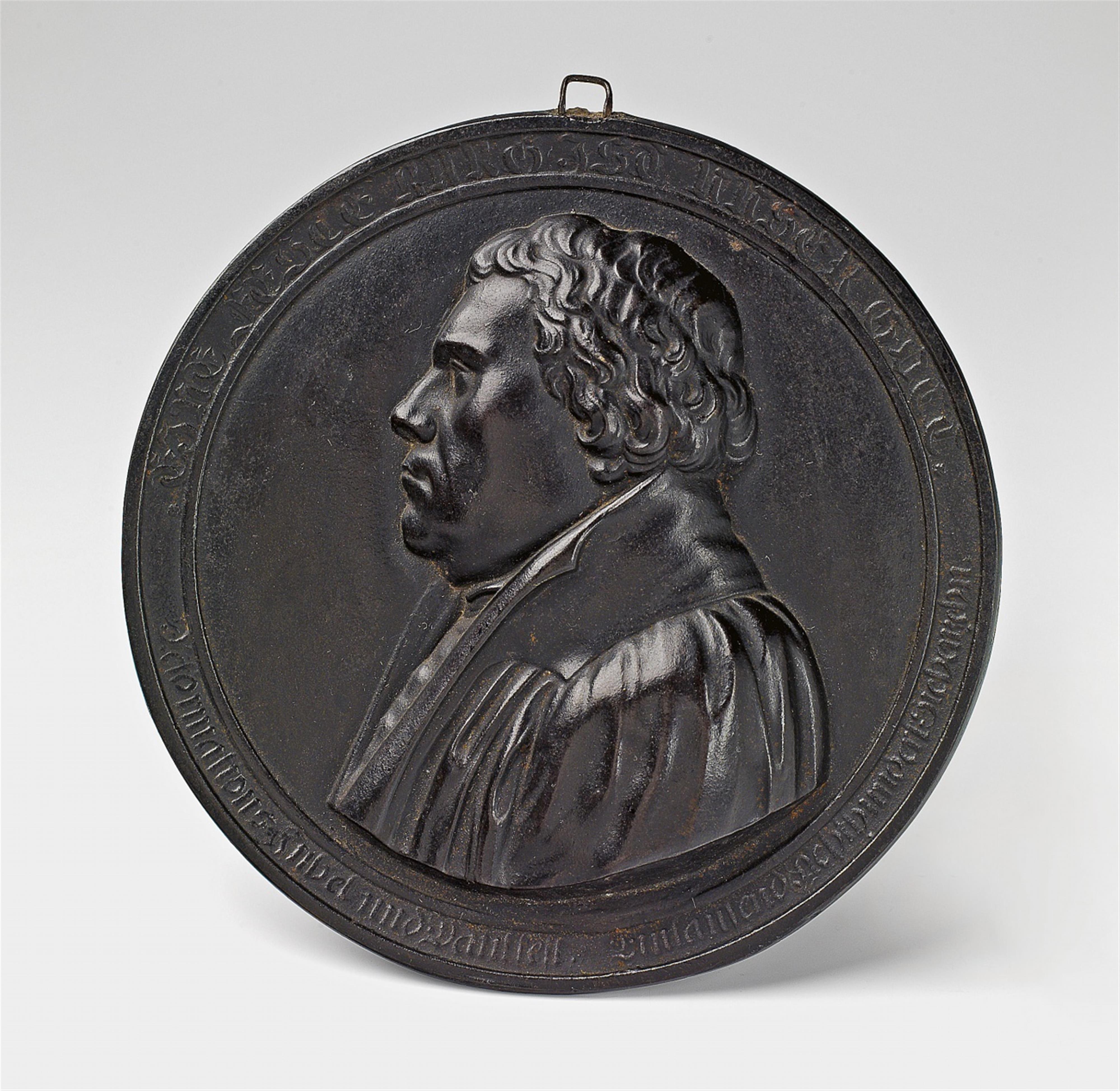 A cast iron medaillon with a portrait of Martin Luther - image-1