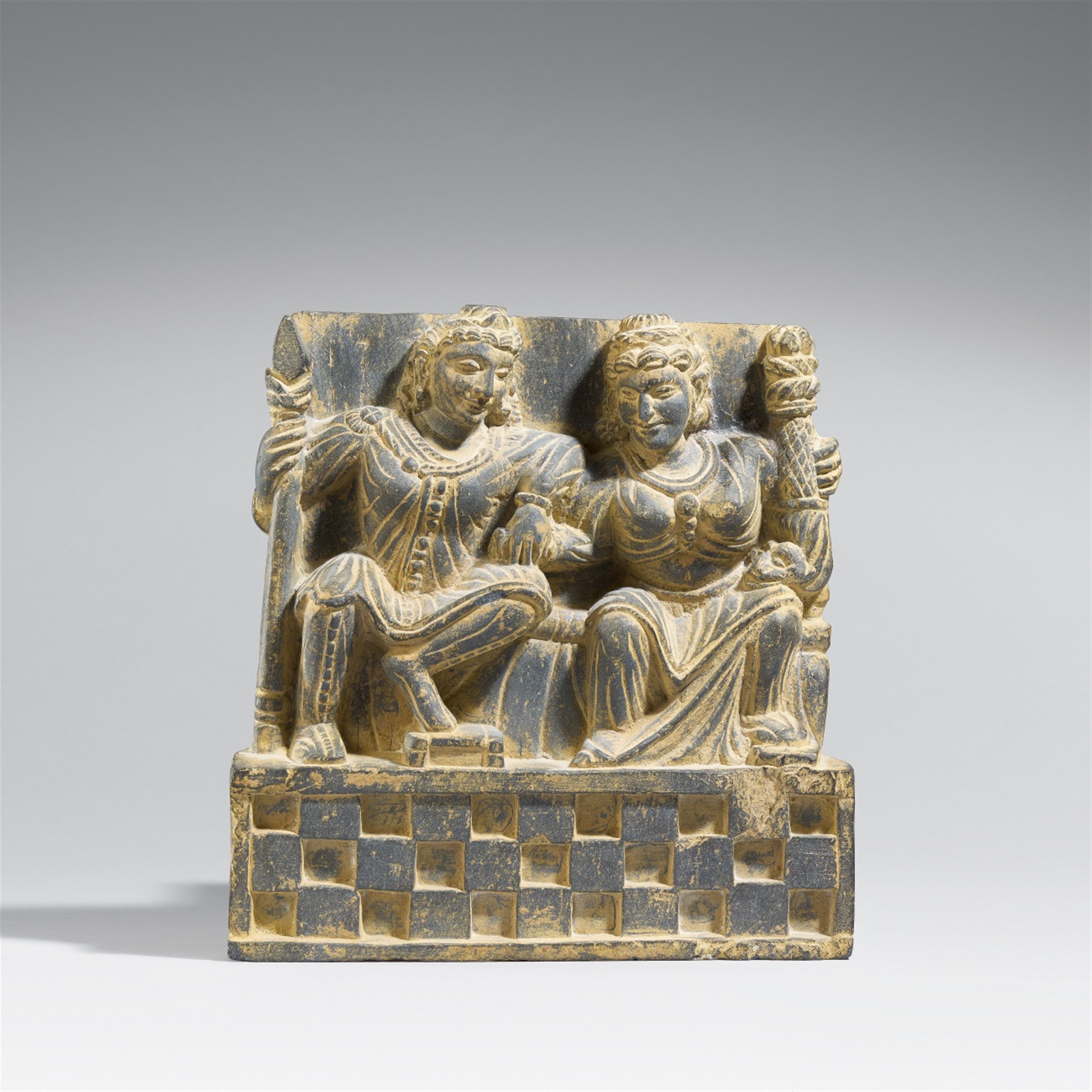 A Gandhara grey schist architectural fragment of Pancika and Hariti. 2nd/3rd century - image-1