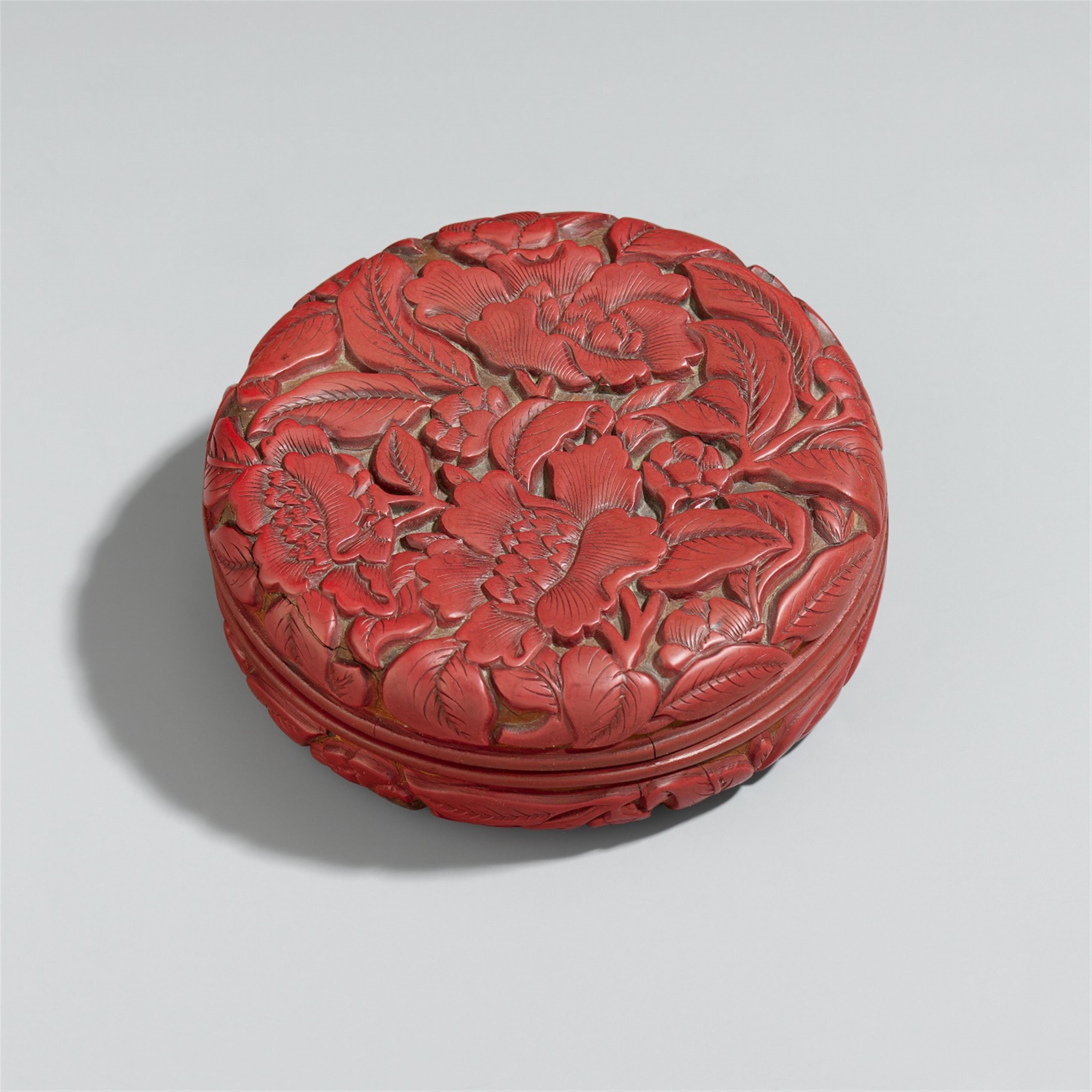 A small, round, red lacquer 'camellia' box. Early Ming dynasty - image-1