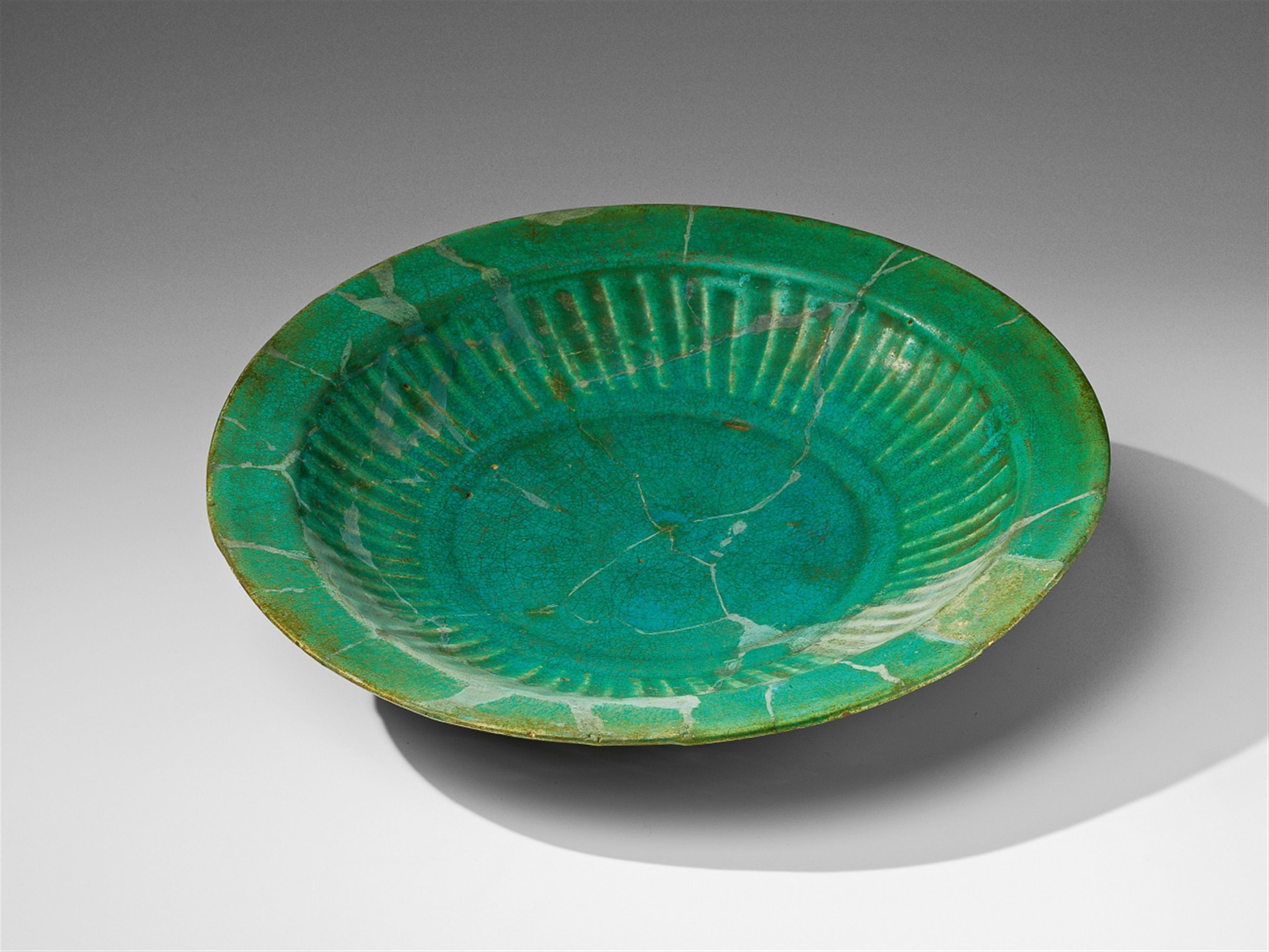 A large, round Iranian fritware plate - image-1