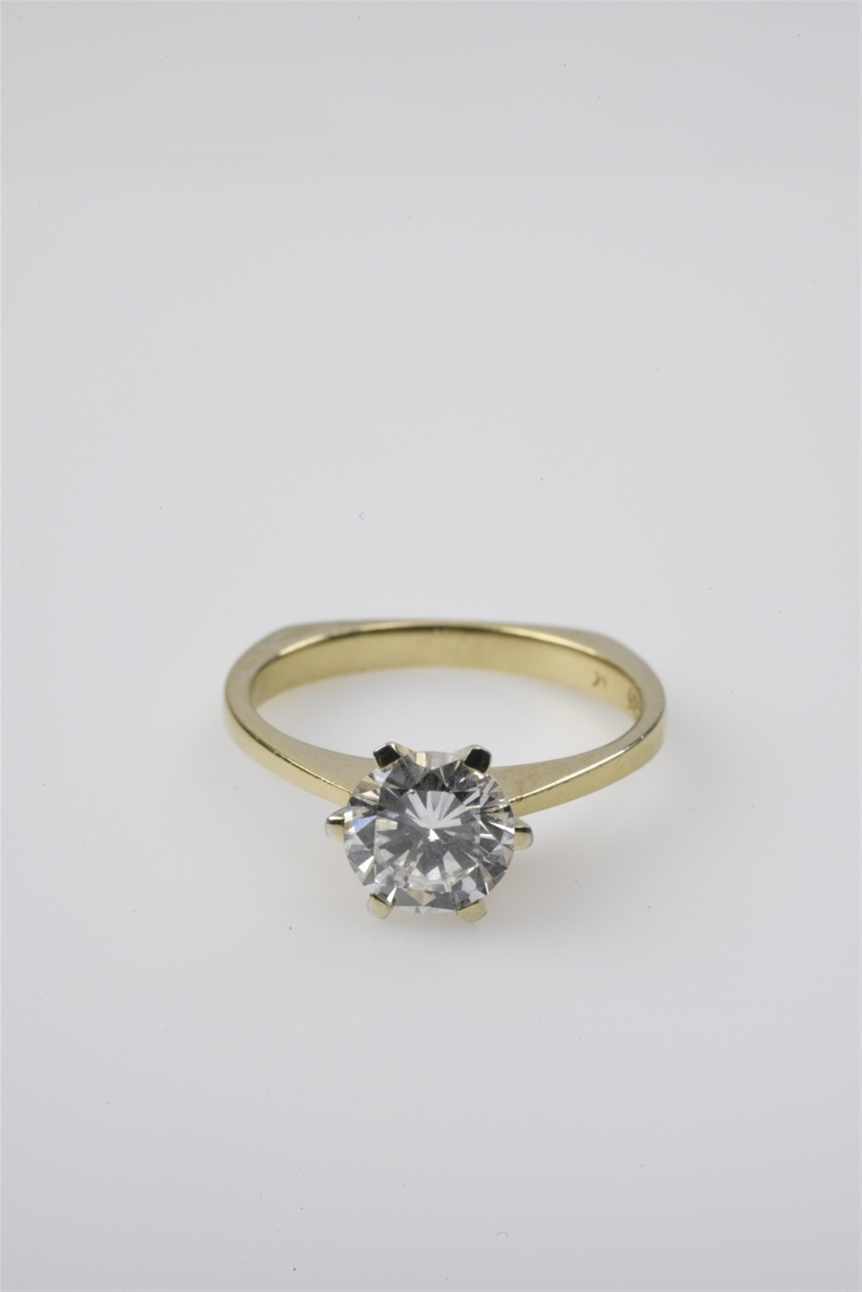 A small 14k gold solitaire diamond ring - image-1