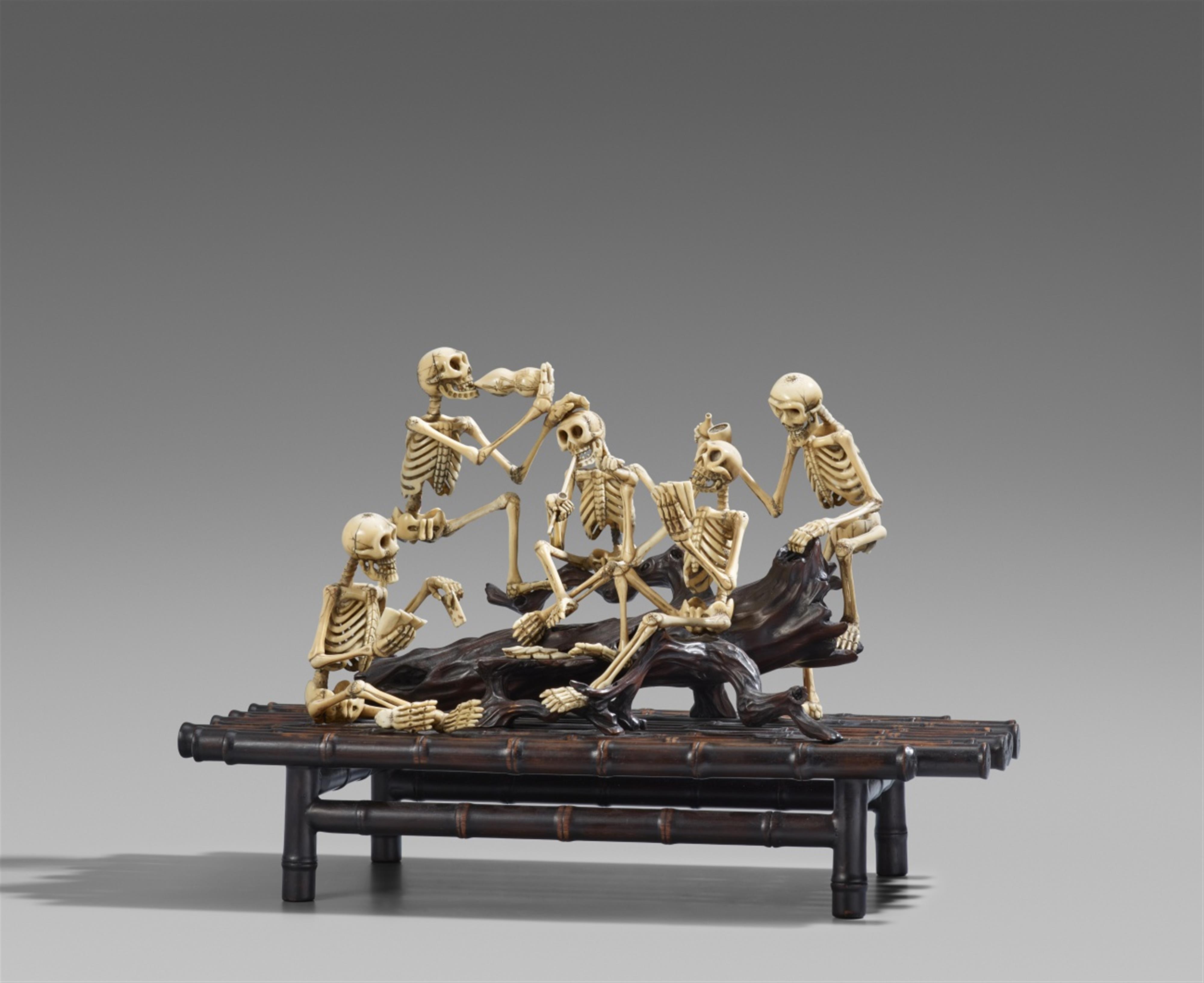 A large ivory, wood and bamboo okimono of five frolicking skeletons. Late 19th century - image-1