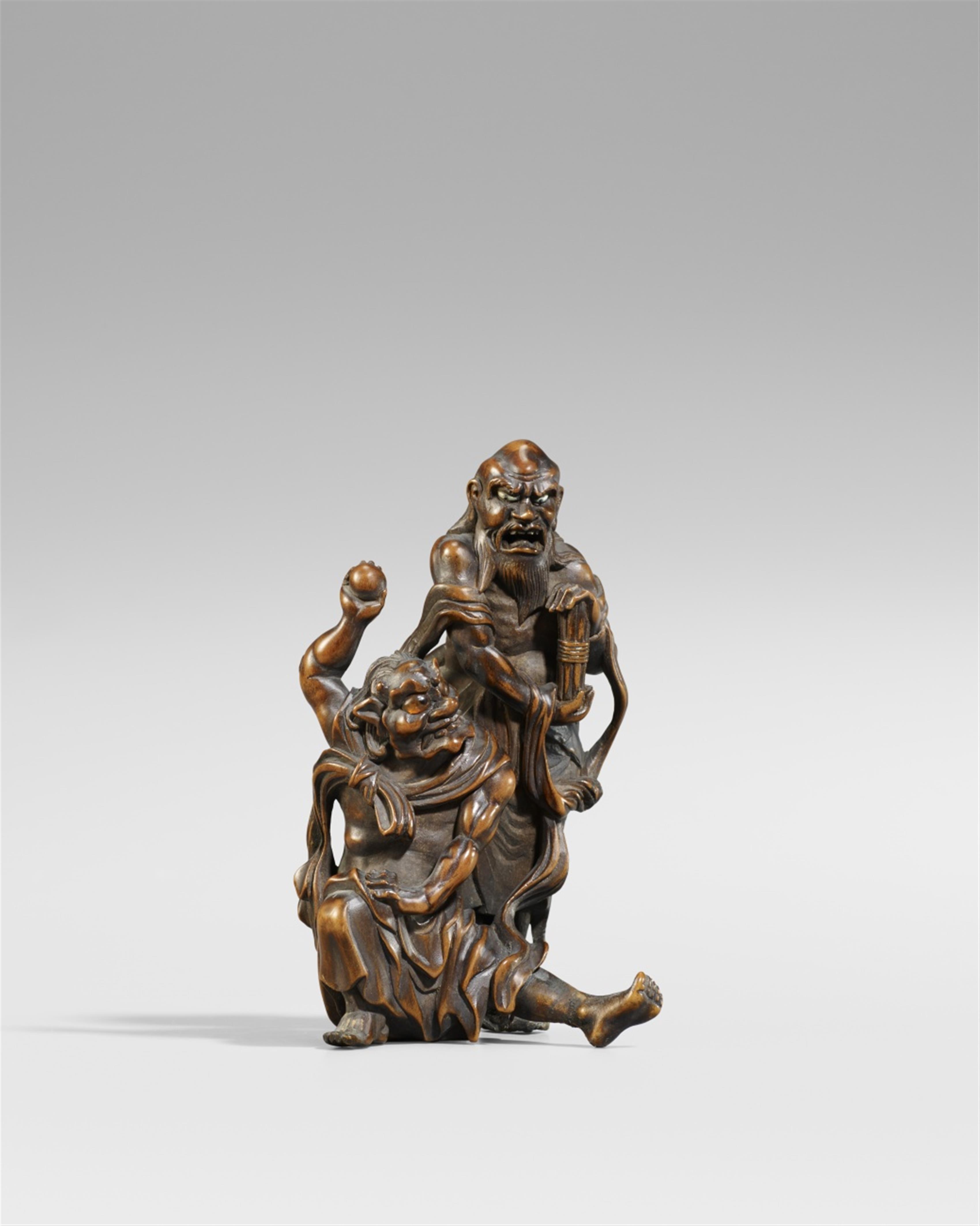 A boxwood okimono of a rakan and oni. Late 19th century - image-1