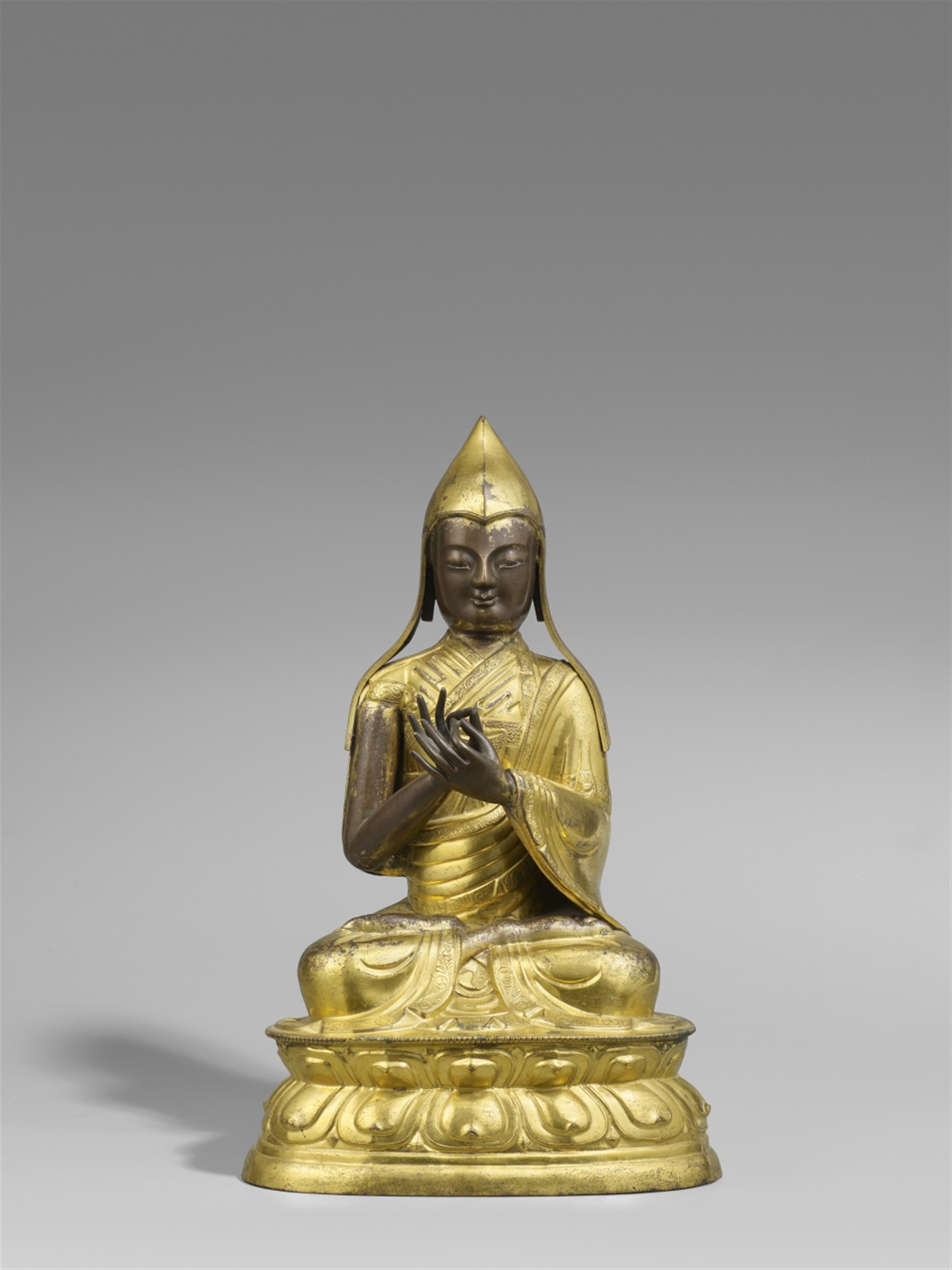 A Sinotibetan gilt copper repoussé figure of a Gelugpa lama. 19th century - image-1