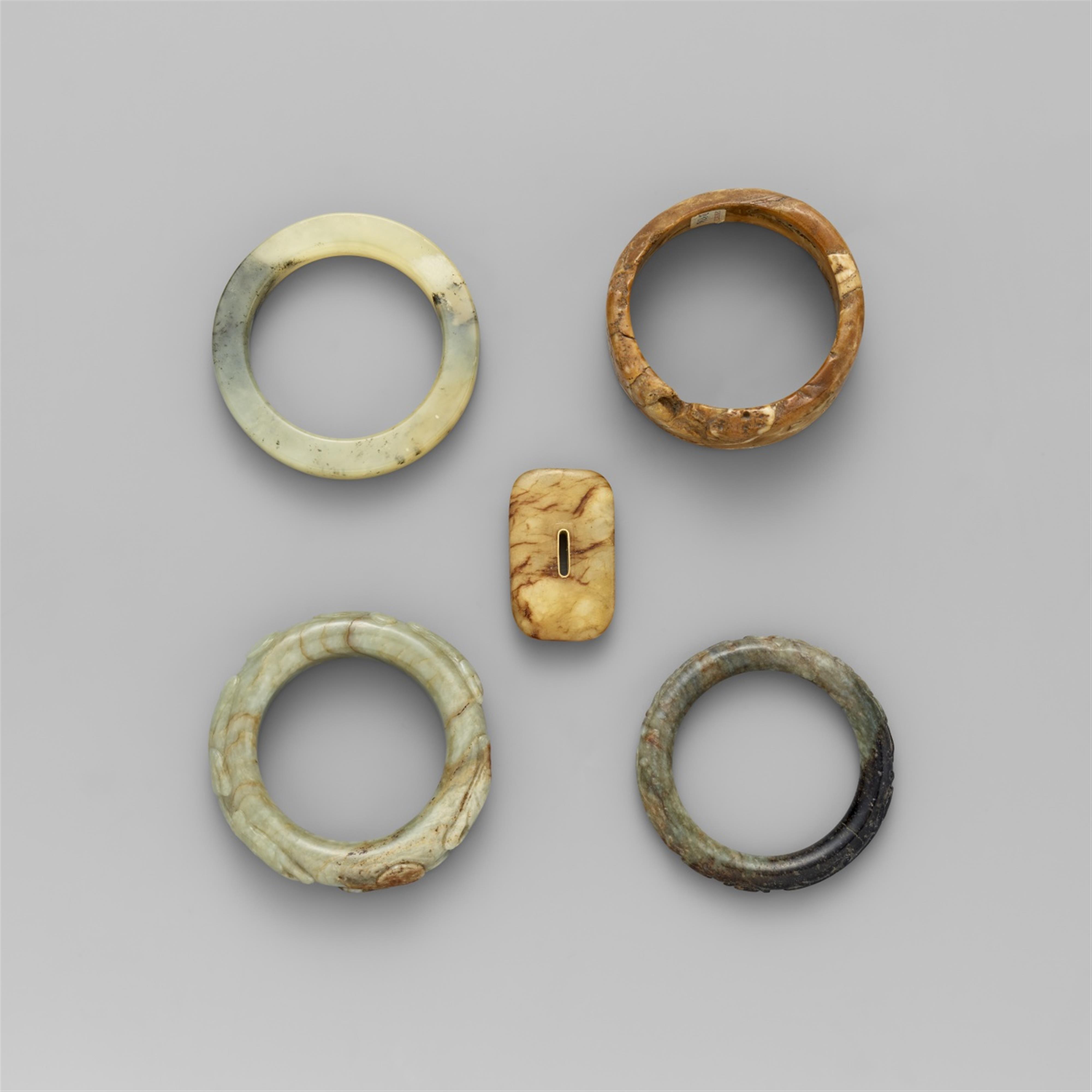 Five jade and stone bangles and a plaque - image-1