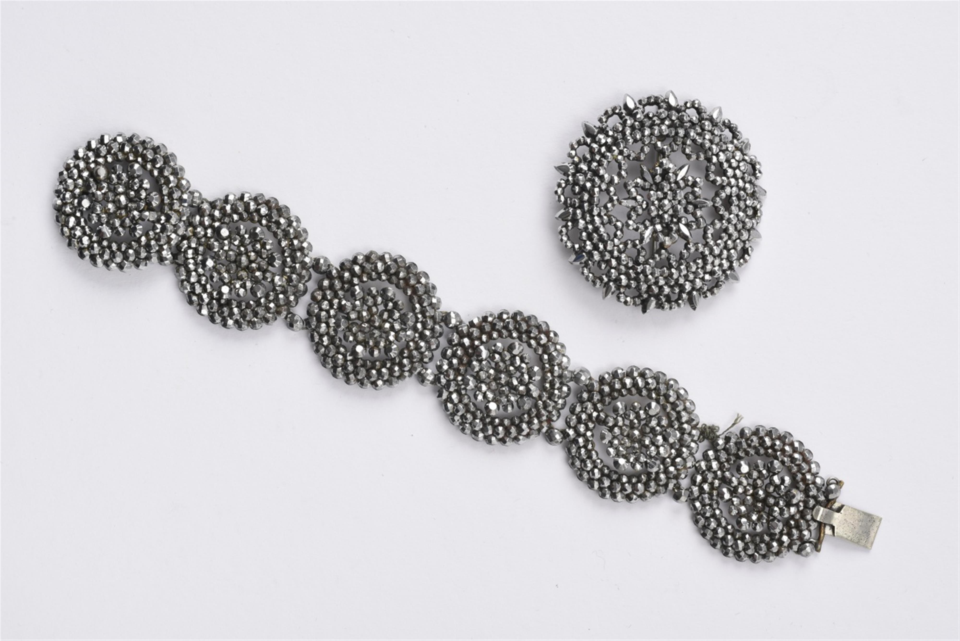 A cut steel bracelet and brooch - image-1