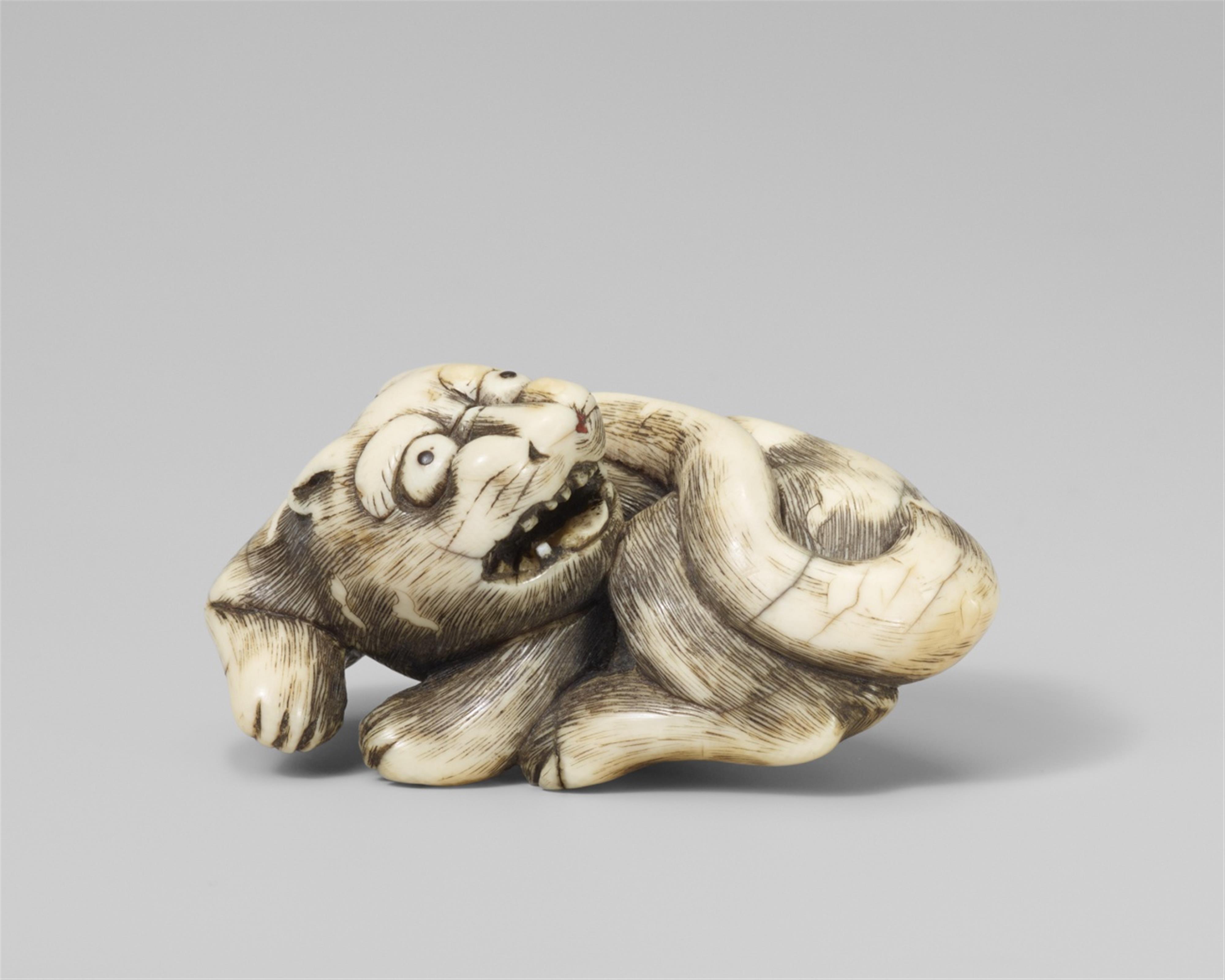 A Kyoto school ivory netsuke of a recumbent tiger. Late 18th century - image-1