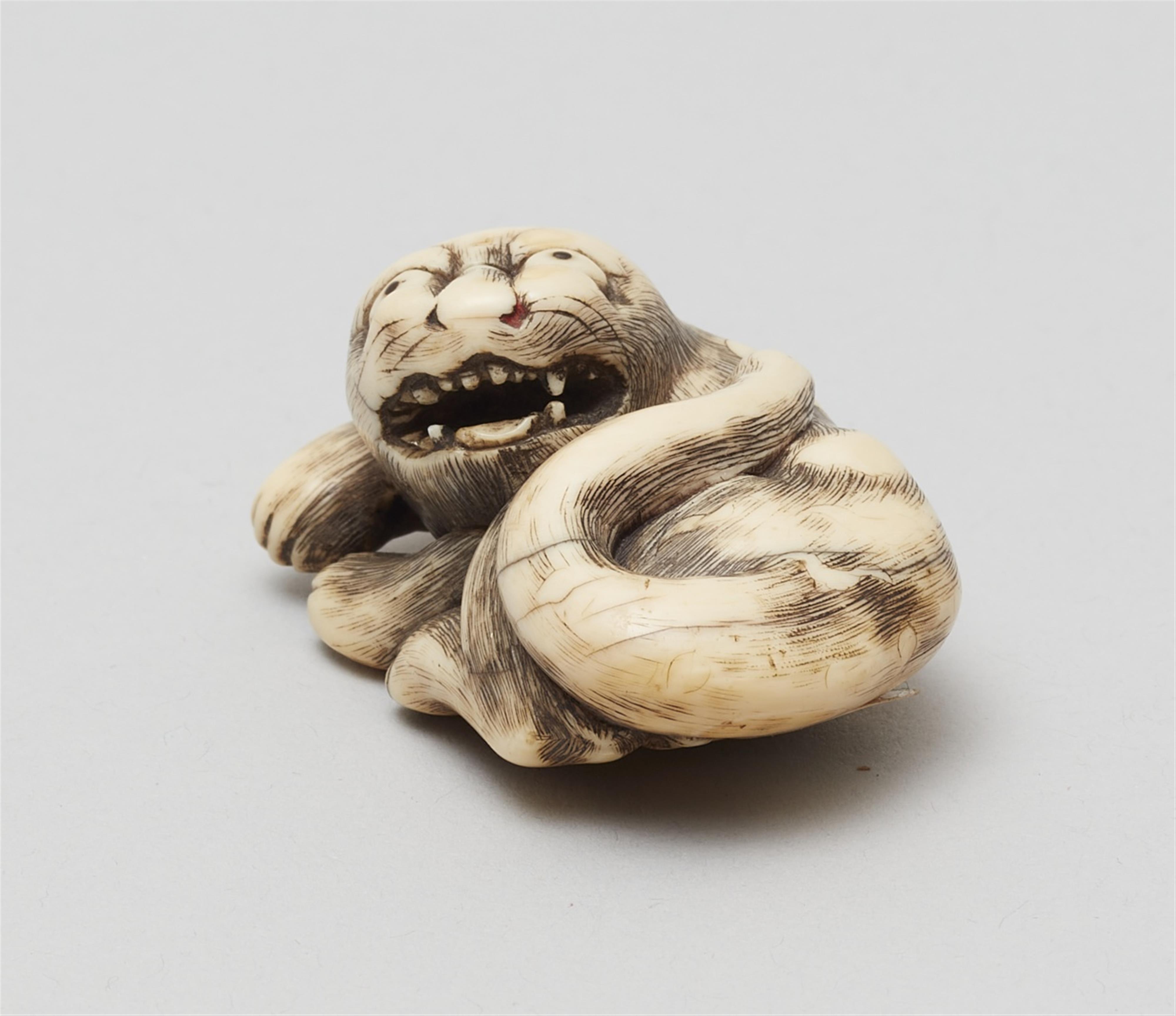 A Kyoto school ivory netsuke of a recumbent tiger. Late 18th century - image-3