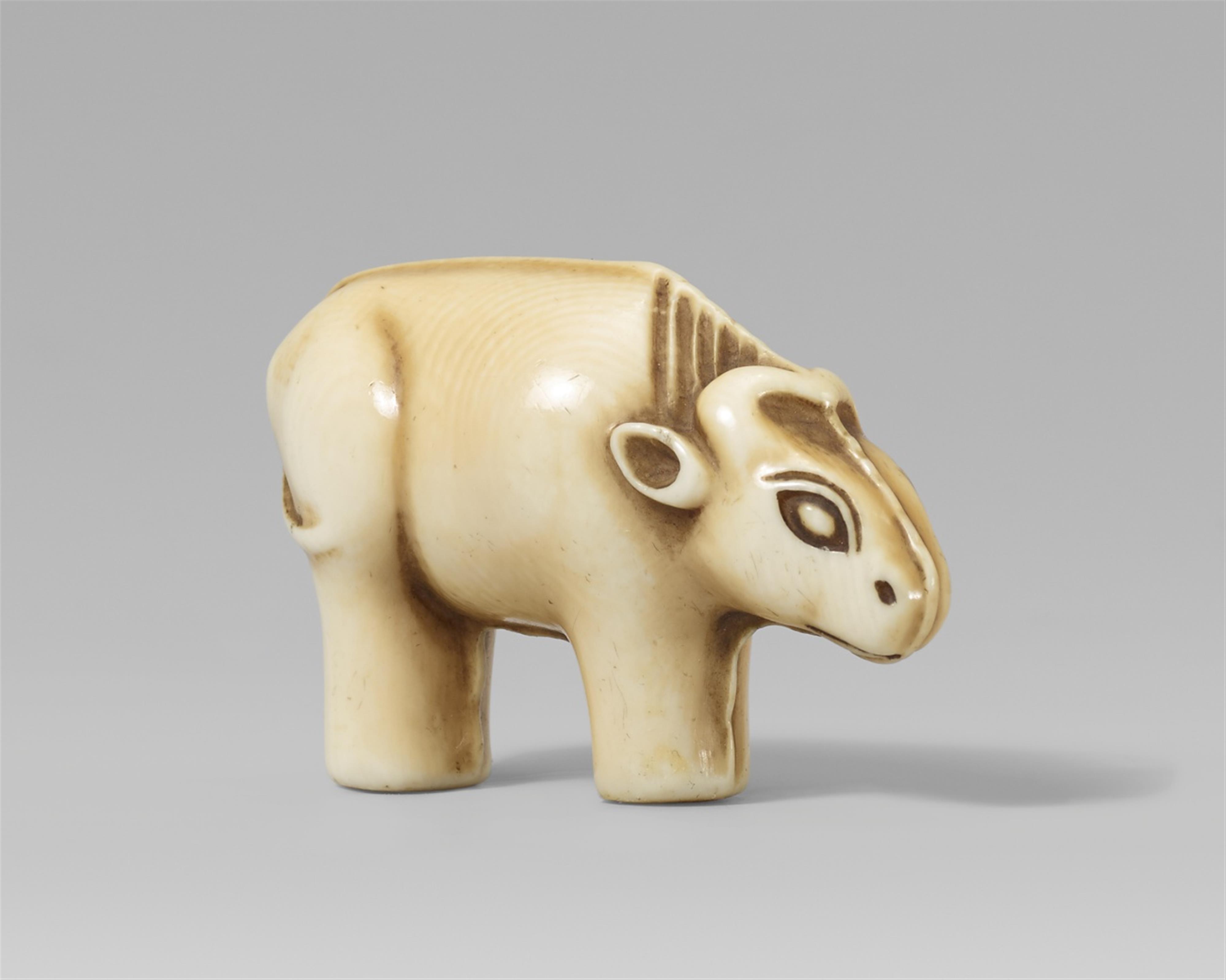 An Osaka school ivory netsuke of a toy figurine of an ox. Mid-19th century - image-1