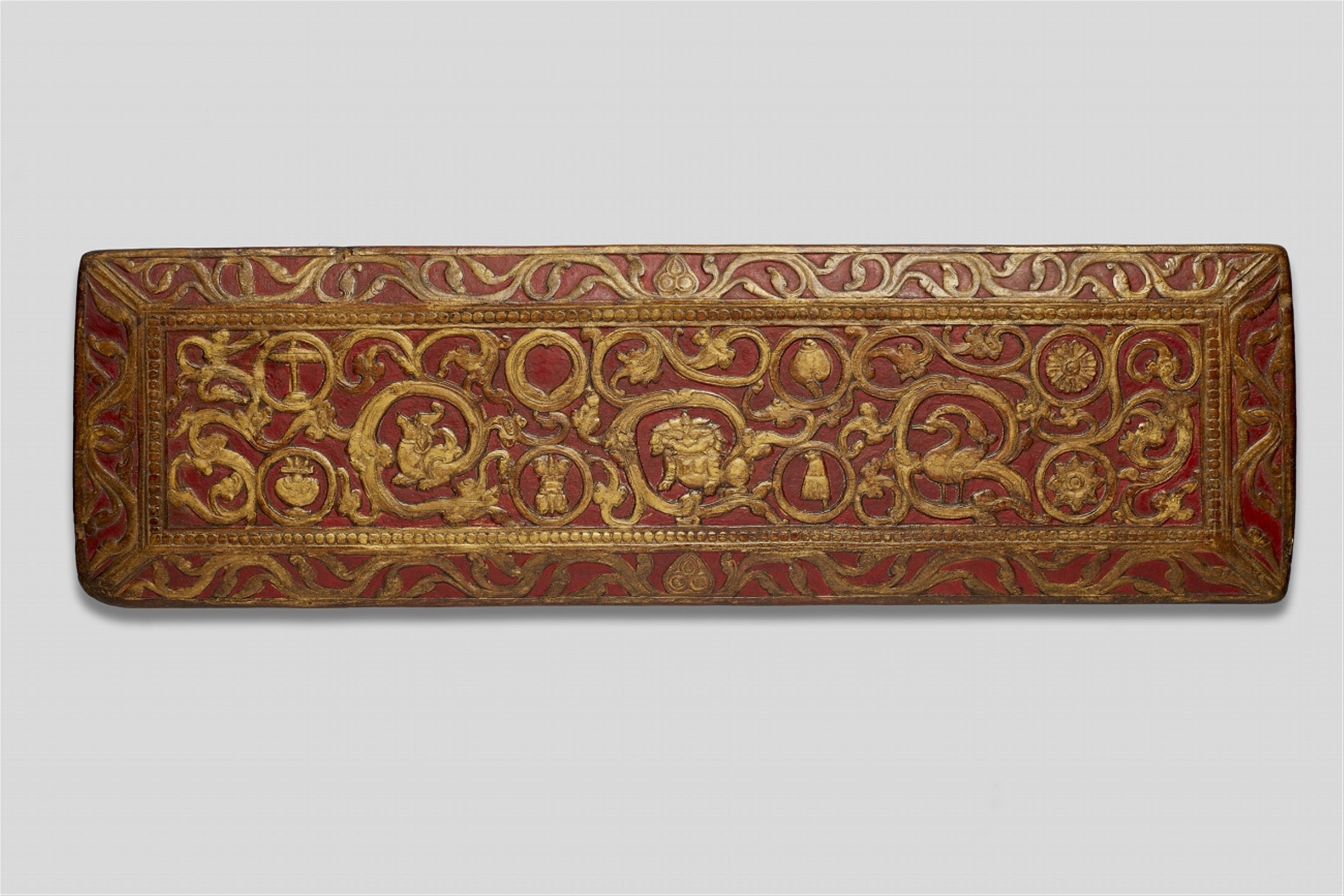 A Tibetan carved, painted and gilt wood manuscript cover. Possibly 14th/15th century - image-1