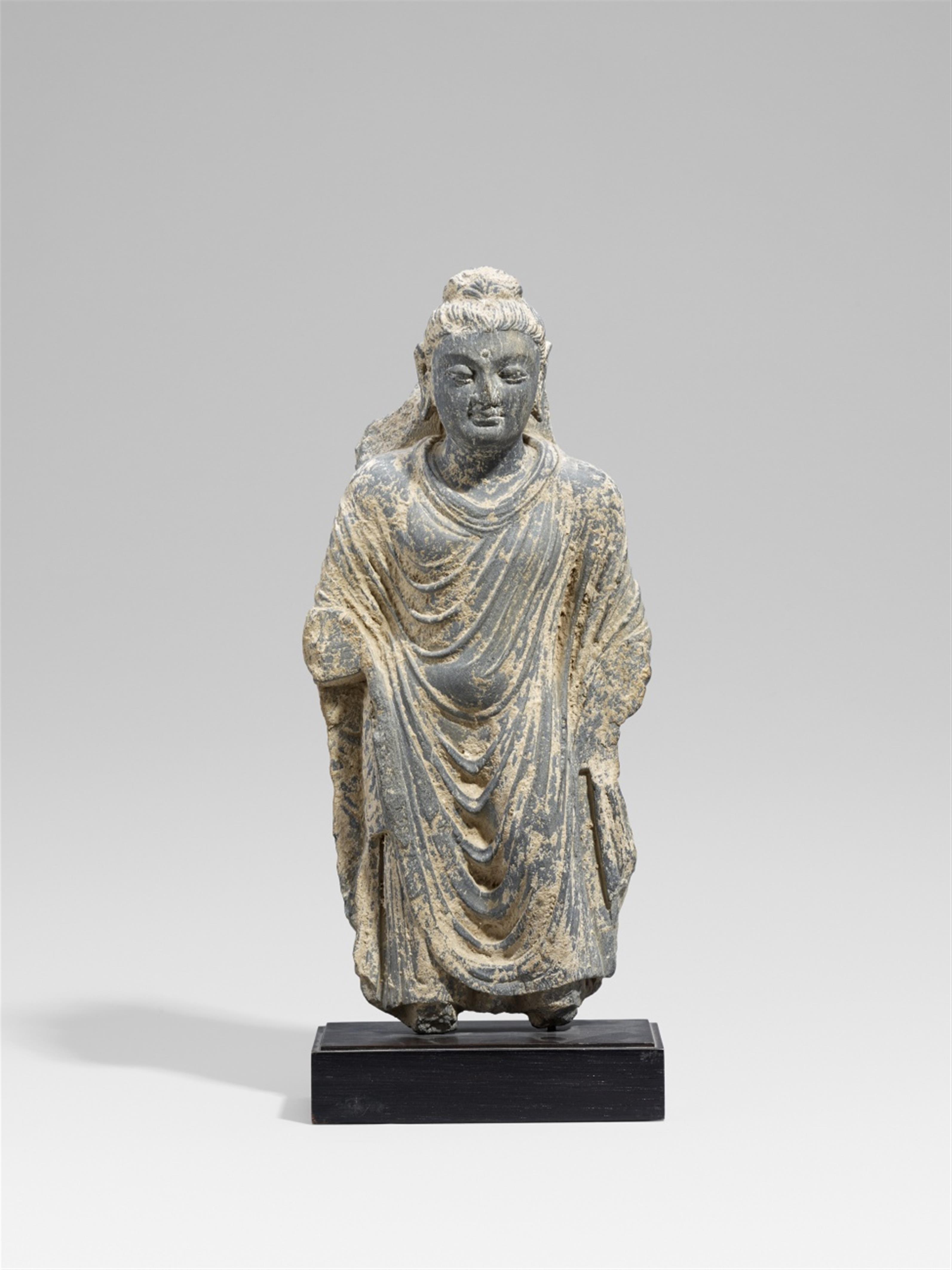 A Gandhara grey schist figure of a standing Buddha. Pakistan. 2nd/3rd century - image-1