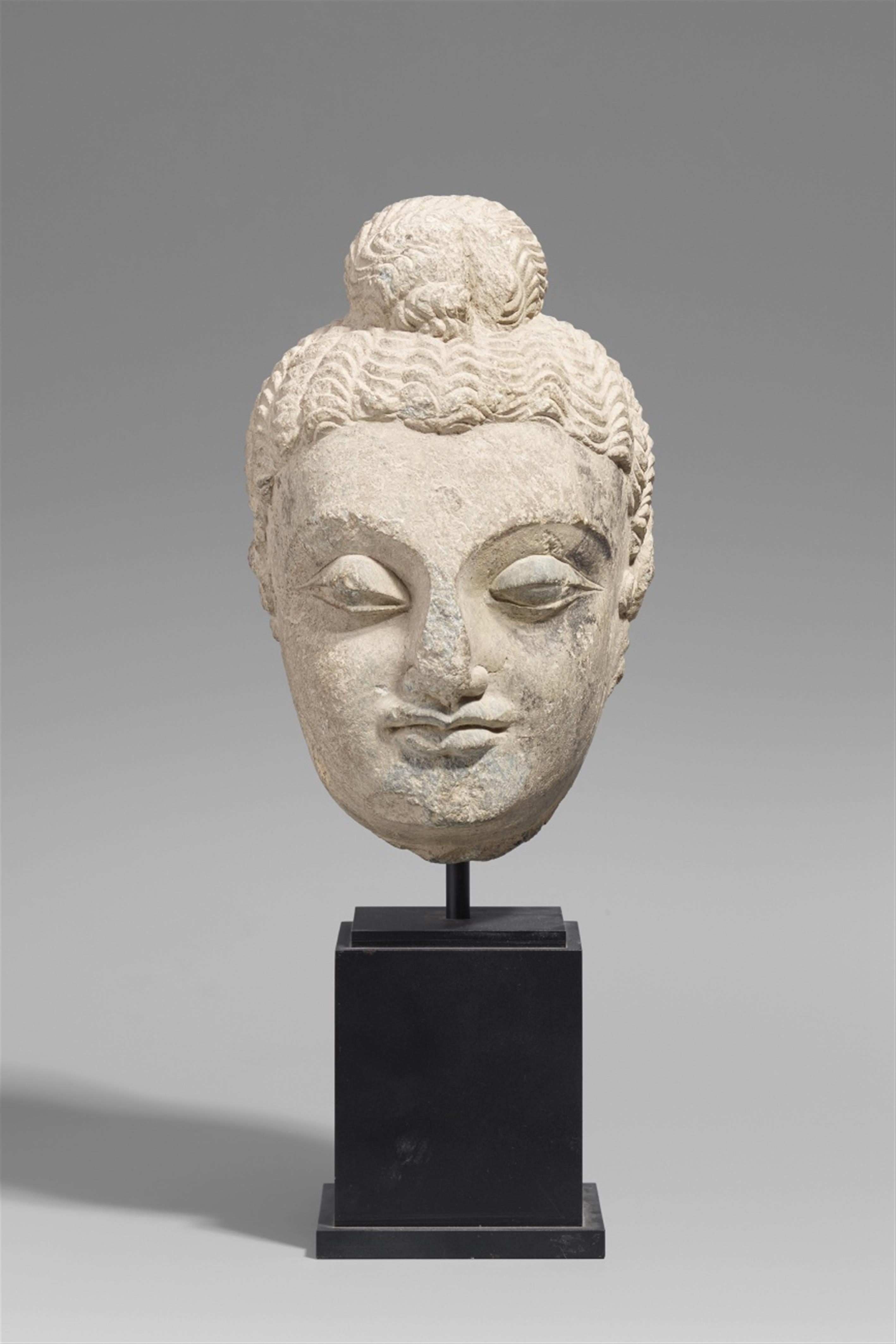 A large Gandhara grey schist head of a Buddha. Pakistan. 2nd/3rd century - image-1