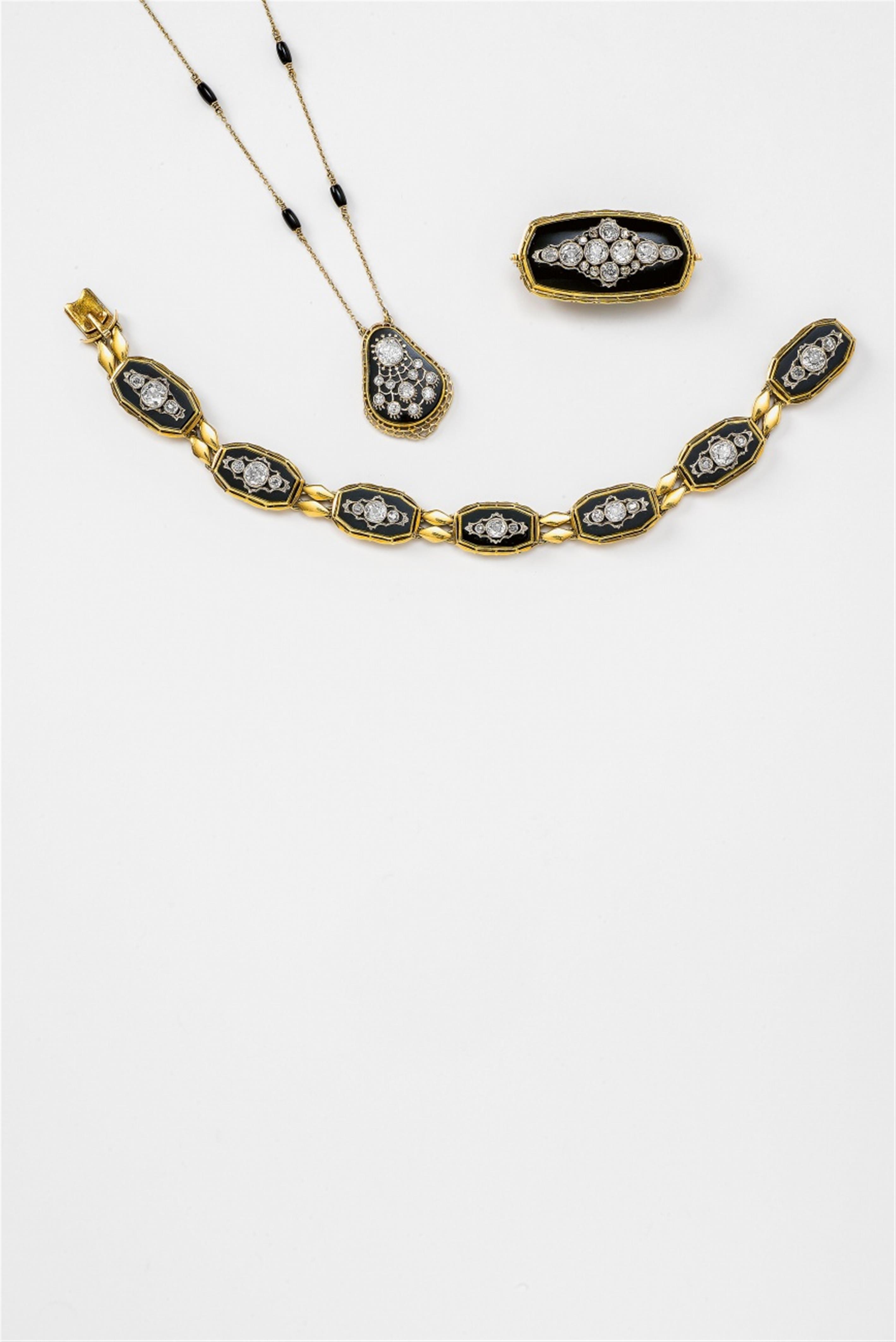 A three-piece 14k gold, diamond and onyx garniture - image-1