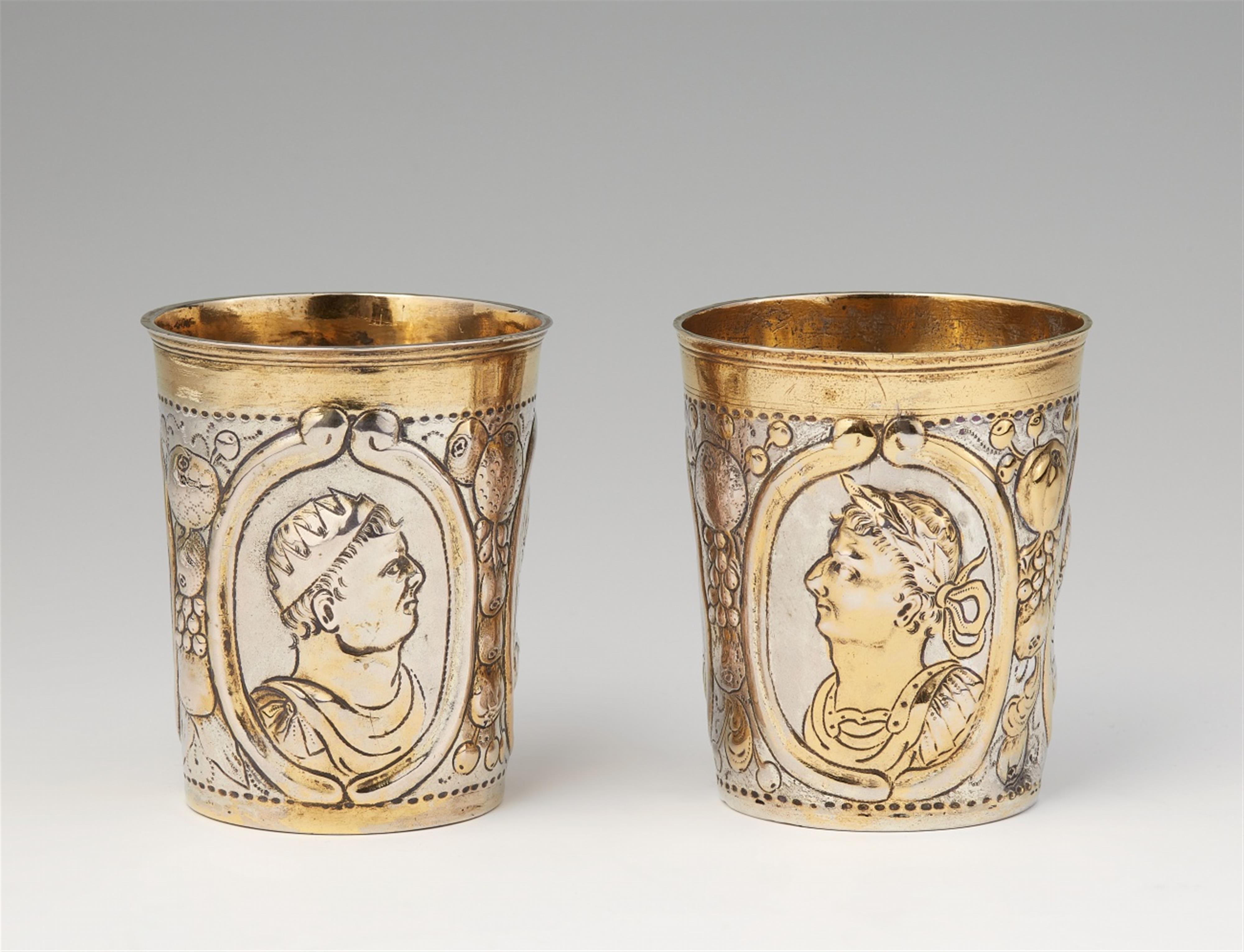 A pair of parcel-gilt Leipzig silver beakers - image-1