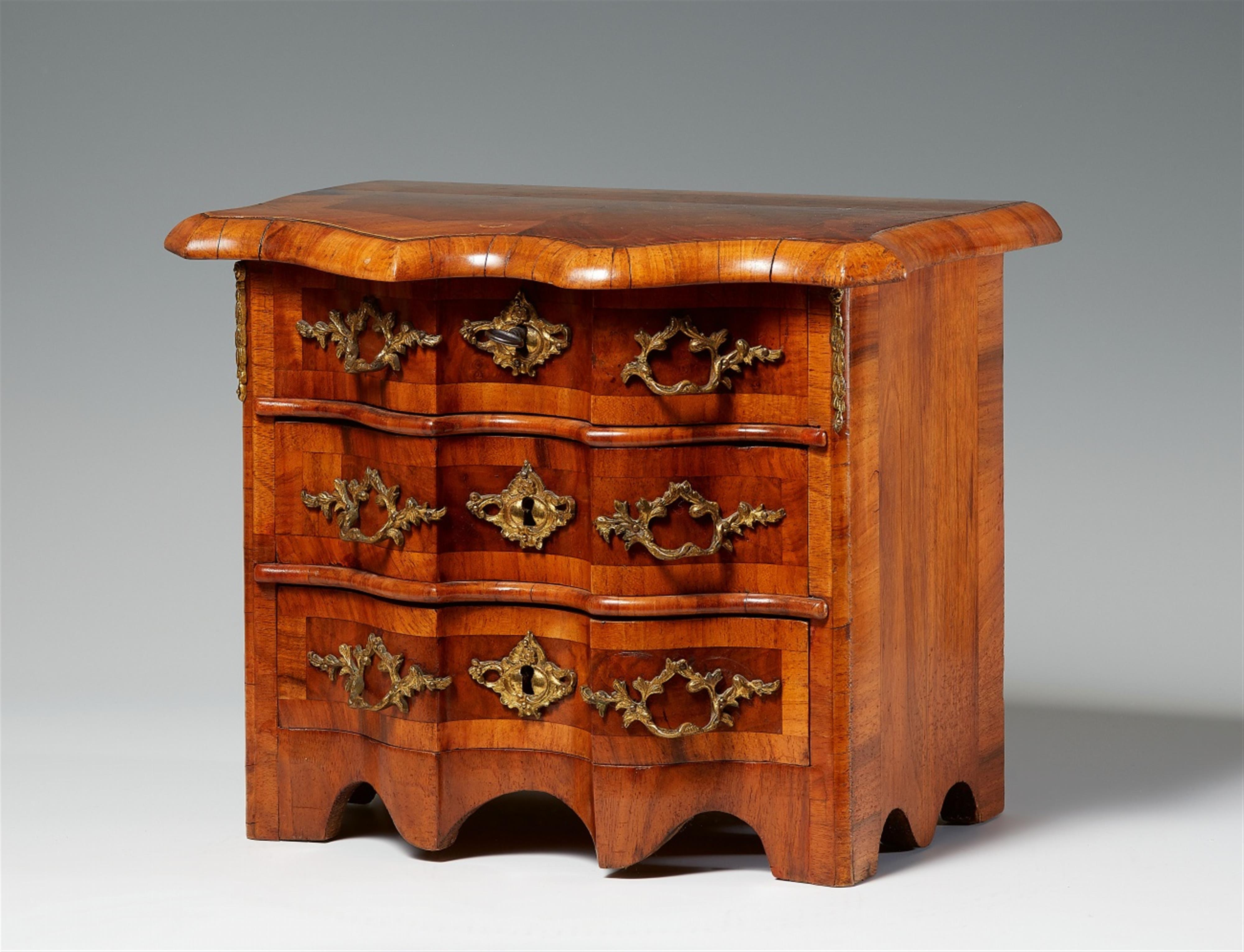 A small walnut veneer chest of drawers - image-1