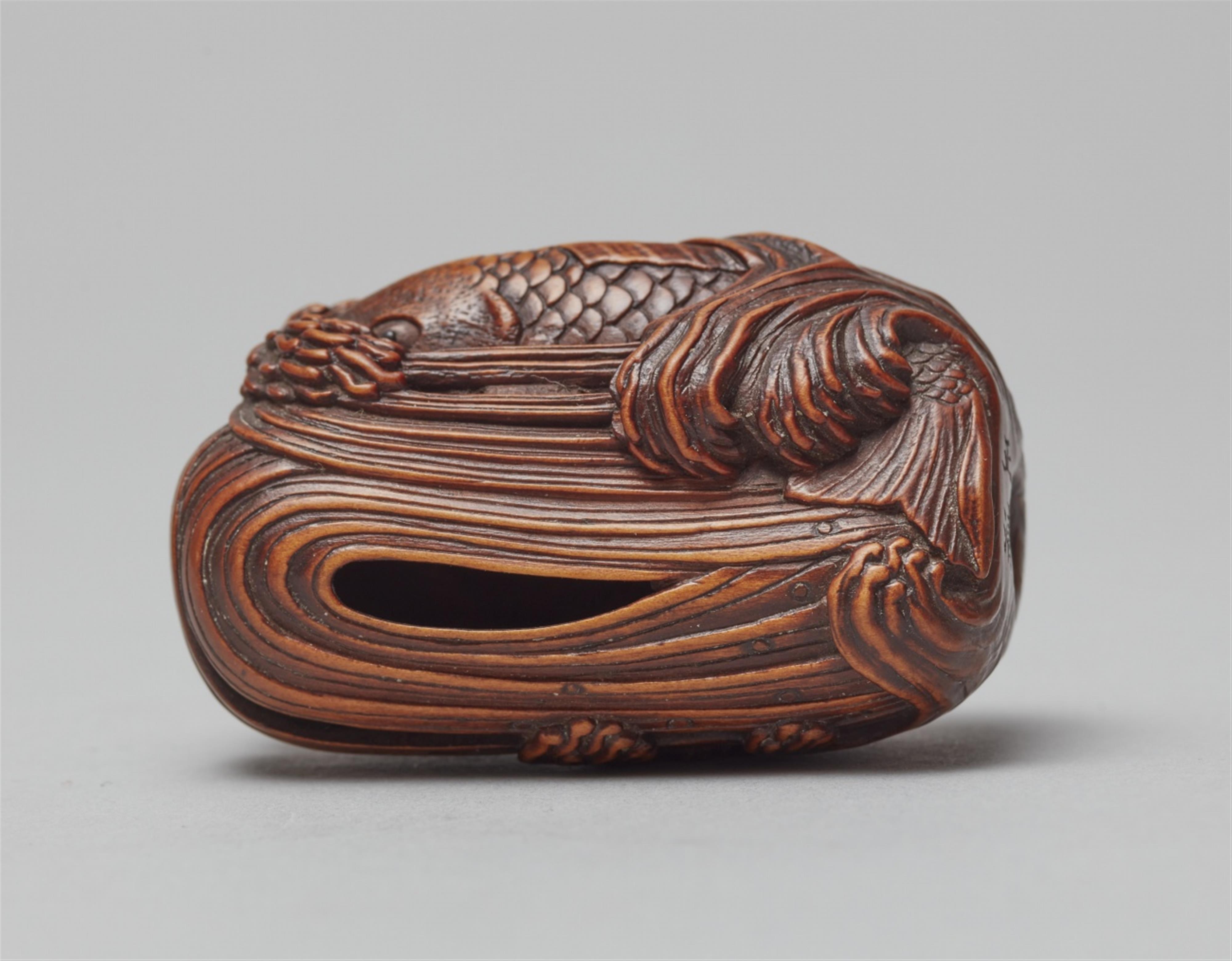 A large boxwood netsuke of a carp leaping up a waterfall. Early 20th century - image-2