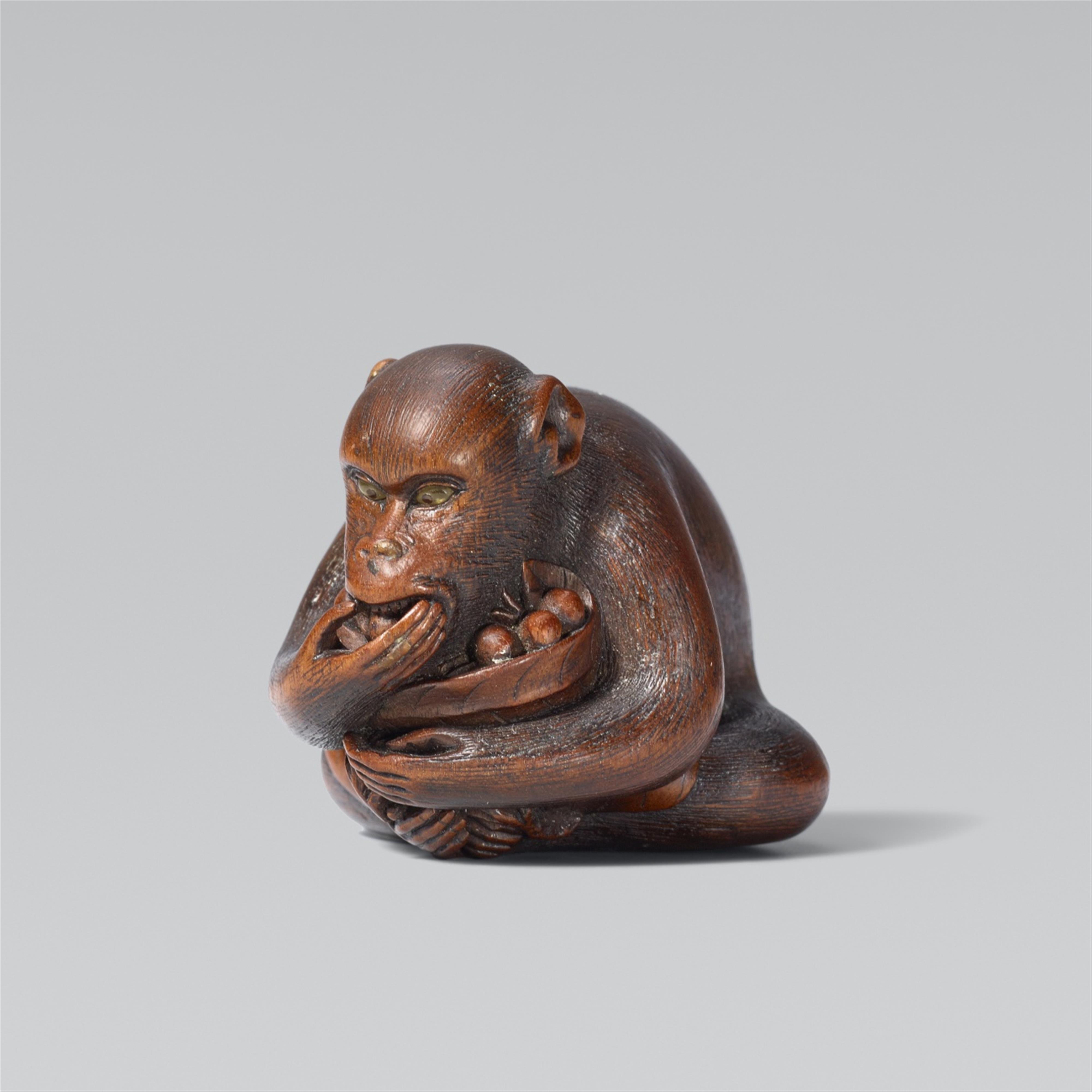 A monkey eating fruit. Boxwood - image-1